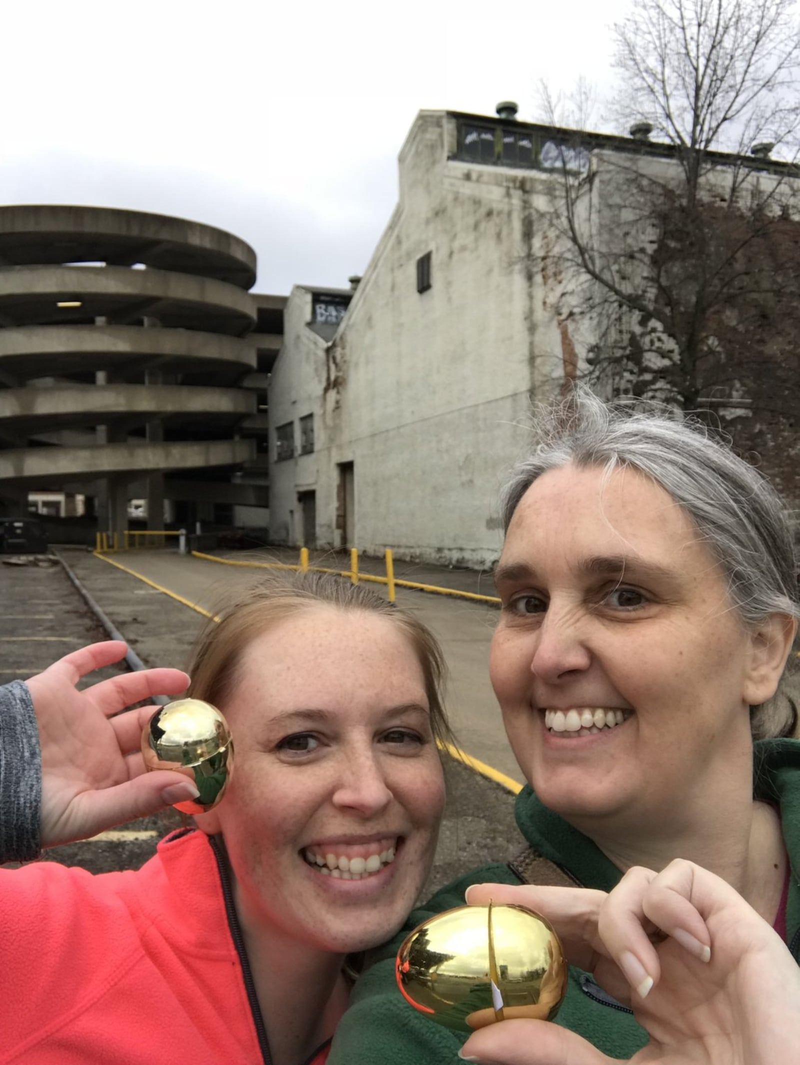 Nicole Board (left) and Melissa Manning show off the golden eggs they found during last year’s Lost in the City egg hunt in Dayton. CONTRIBUTED