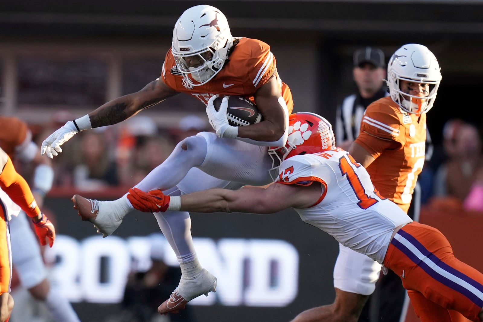 Texas running back Jaydon Blue (23) tries to break a tackle by Clemson linebacker Wade Woodaz (17) during the first half in the first round of the College Football Playoff, Saturday, Dec. 21, 2024, in Austin, Texas. (AP Photo/Eric Gay)