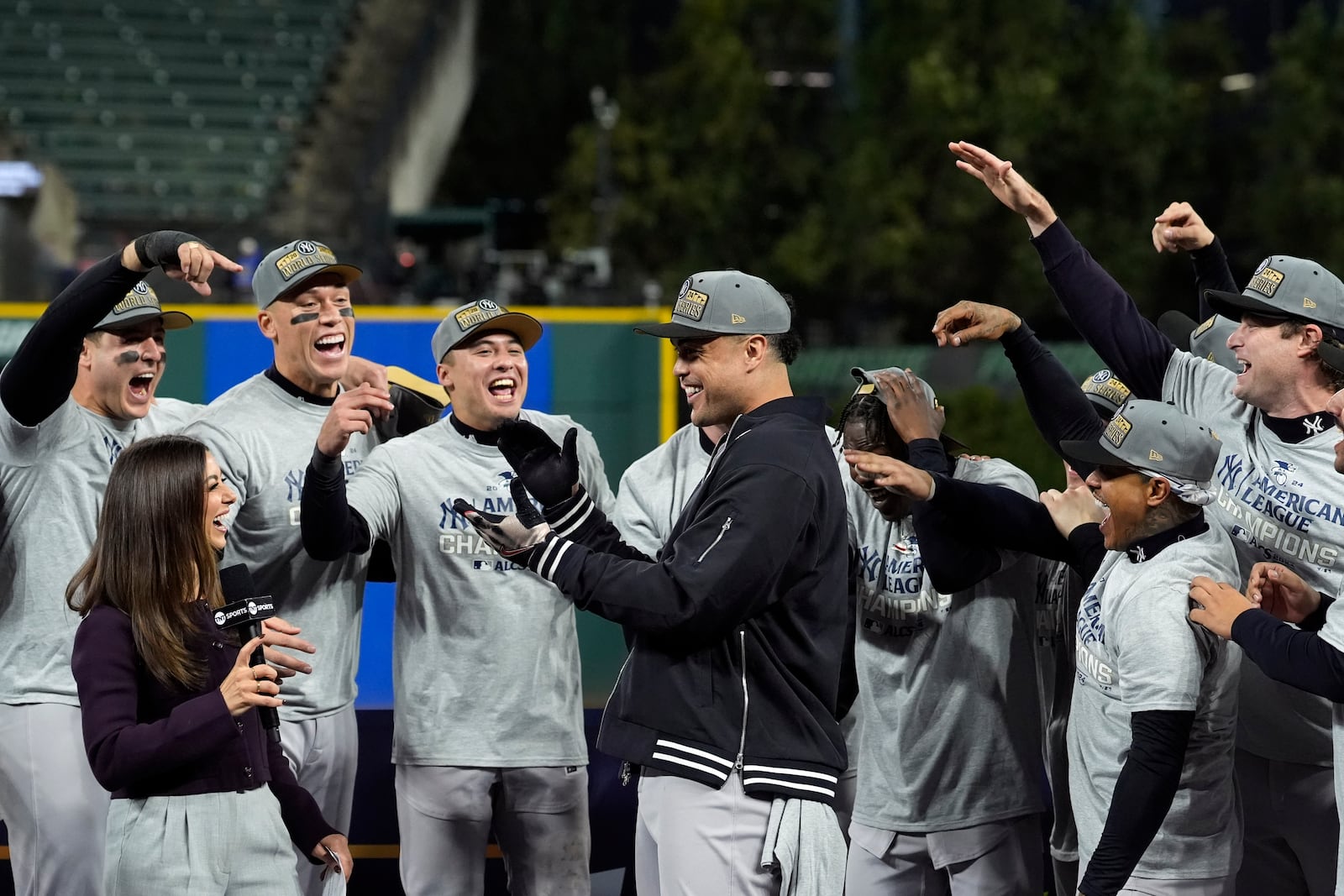 New York Yankees cheer for series MVP Giancarlo Stanton, center, after Game 5 of the baseball AL Championship Series against the Cleveland Guardians Sunday, Oct. 20, 2024, in Cleveland. (AP Photo/Godofredo A. Vásquez )