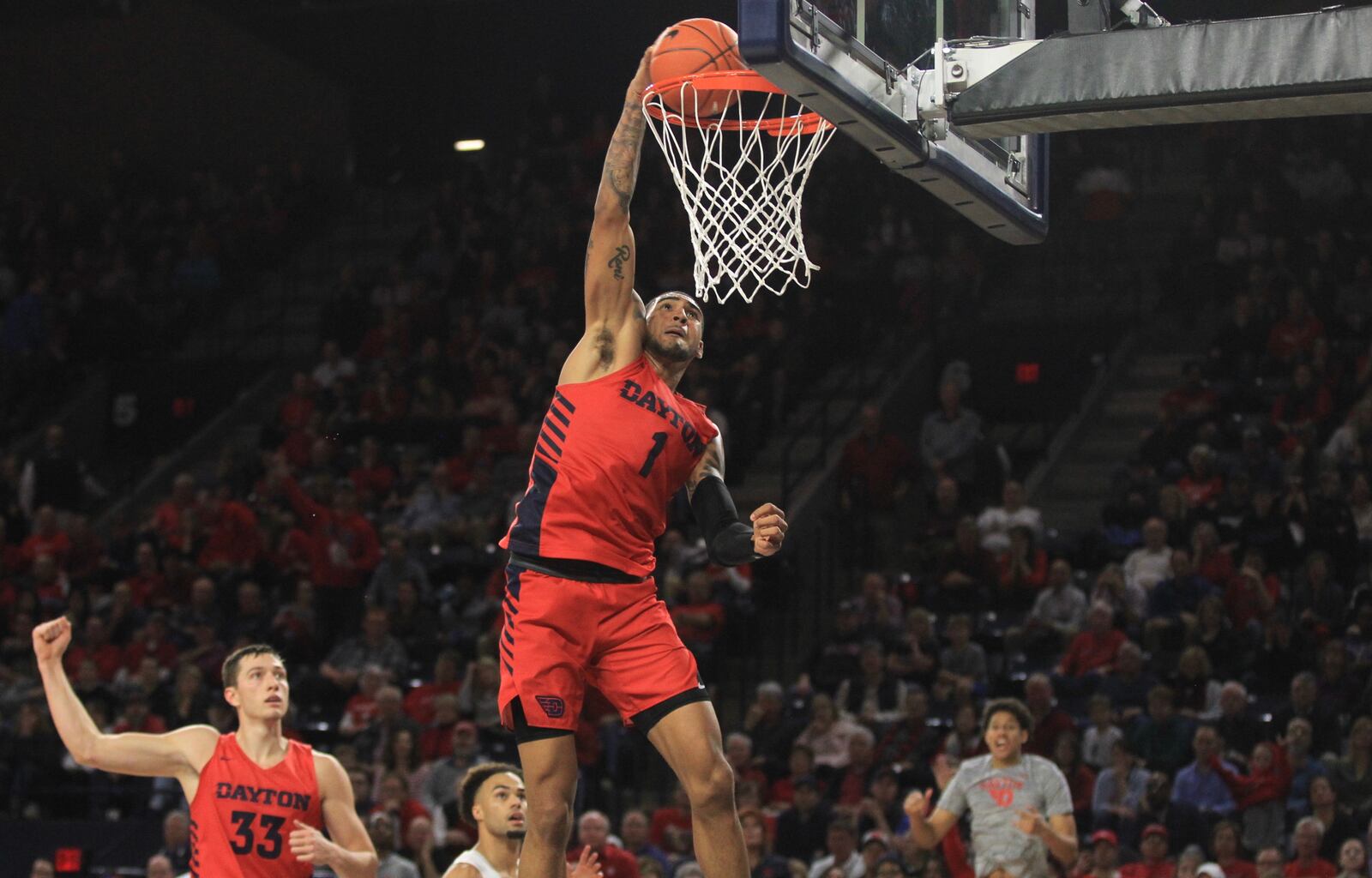 Dayton's Obi Toppin dunks against Richmond as Ryan Mikesell reacts in the background on Saturday, Jan. 25, 2020, at the Robins Center in Richmond, Va.