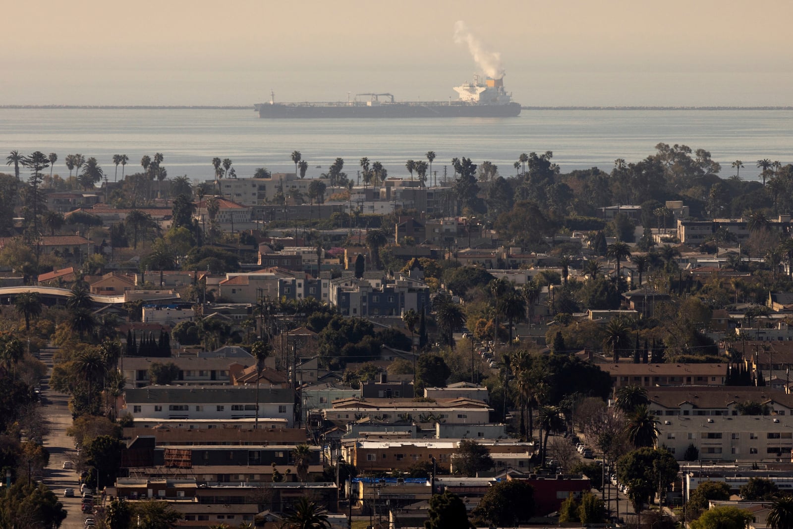 A commercial ship is visible off the shore in front of Long Beach, Calif., Monday, March 10, 2025. (AP Photo/Etienne Laurent)