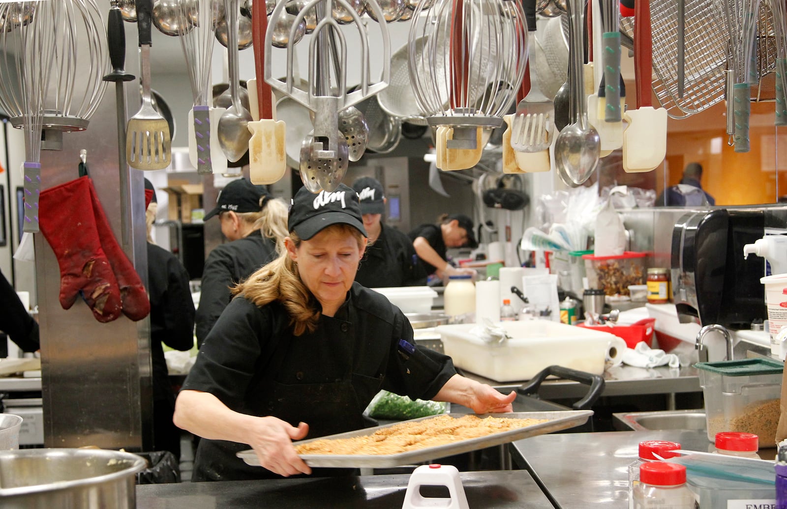 Kim Spanel is among the many kitchen cooks at Dorothy Lane Market's Washington Twp. store who will prepare thousands of pounds of food for Thanksgiving. LISA POWELL / STAFF