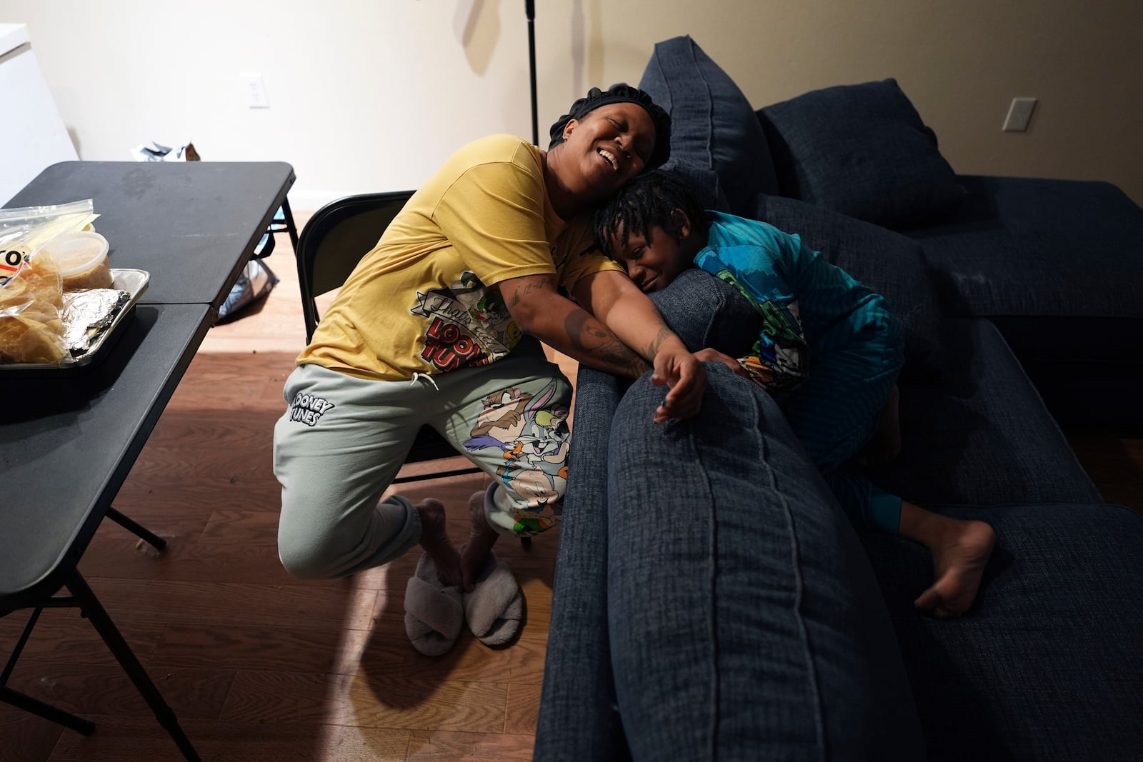 TiAnna Yeldell, left, spends time with her son Ivan, 8, right, at her home, Thursday, Nov. 14, 2024, in Missouri City, Texas. (AP Photo/Eric Gay)