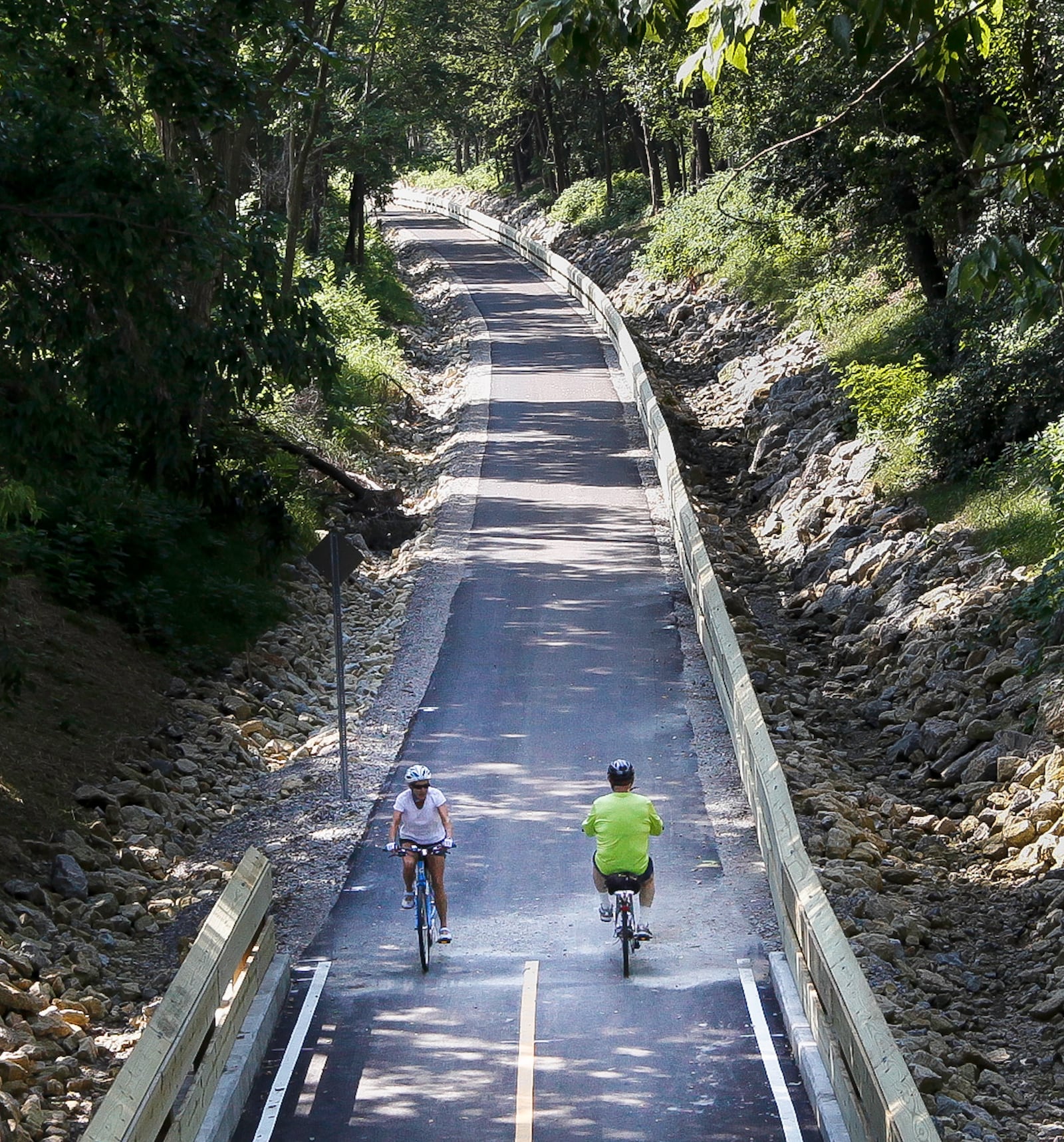 A Dayton sewer access road between Patterson and Shroyer roads has been converted into a new section of a bikeway. The section is part of work, now open, that completes a network from the University of Dayton south to I-675 in Centerville. CHRIS STEWART / STAFF