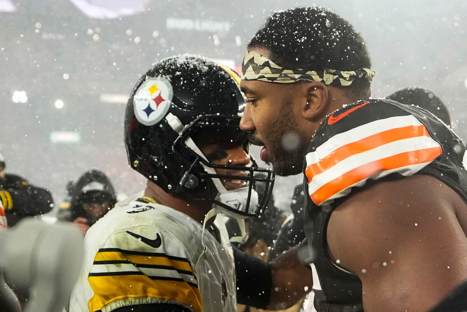 Pittsburgh Steelers quarterback Russell Wilson, left, greets Cleveland Browns defensive end Myles Garrett (95) after an NFL football game, Thursday, Nov. 21, 2024, in Cleveland. The Browns won 24-19. (AP Photo/Sue Ogrocki)