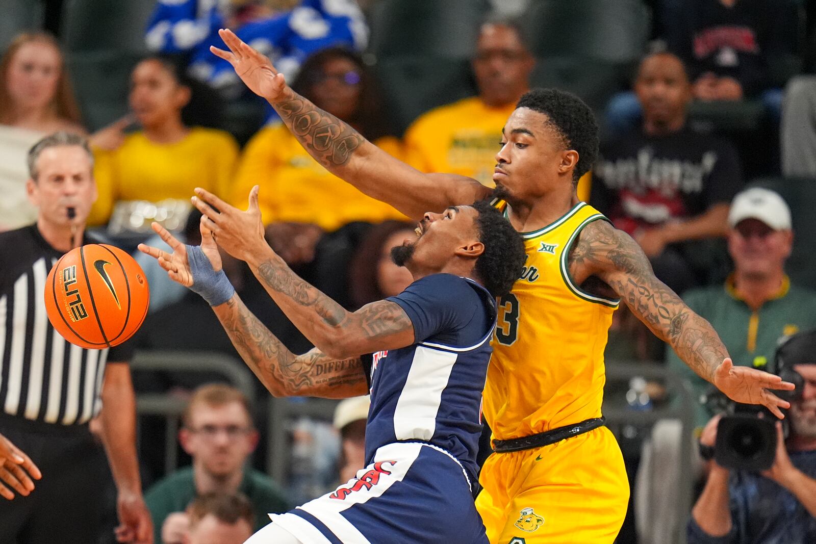 Arizona guard KJ Lewis, left, loses the ball while driving to the basket against Baylor guard Langston Love during the first half of an NCAA college basketball game Monday, Feb. 17, 2025, in Waco, Texas. (AP Photo/Julio Cortez)