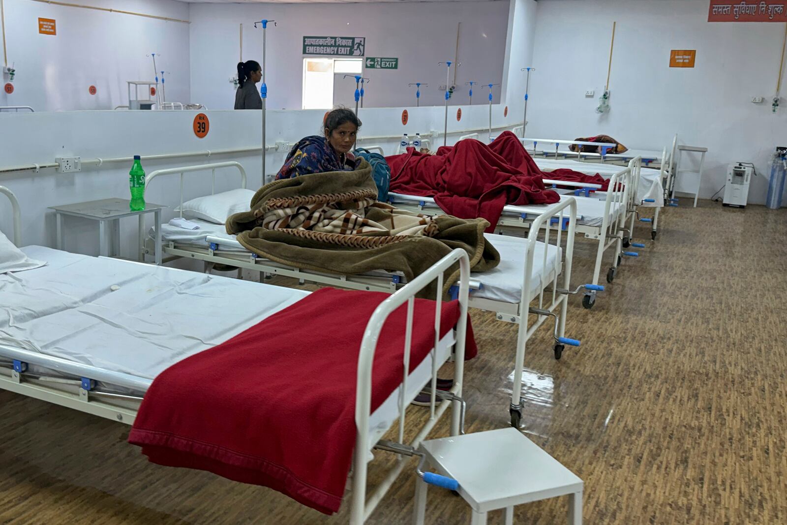 A woman who was injured in a stampede when Hindu devotees rushed to take a holy bath in the Sangam, the confluence of the Ganges, the Yamuna and the mythical Saraswati rivers, during the Maha Kumbh festival, receives treatment at a hospital in Prayagraj, India, Wednesday, Jan. 29, 2025. (AP Photo/Rajesh Kumar Singh)