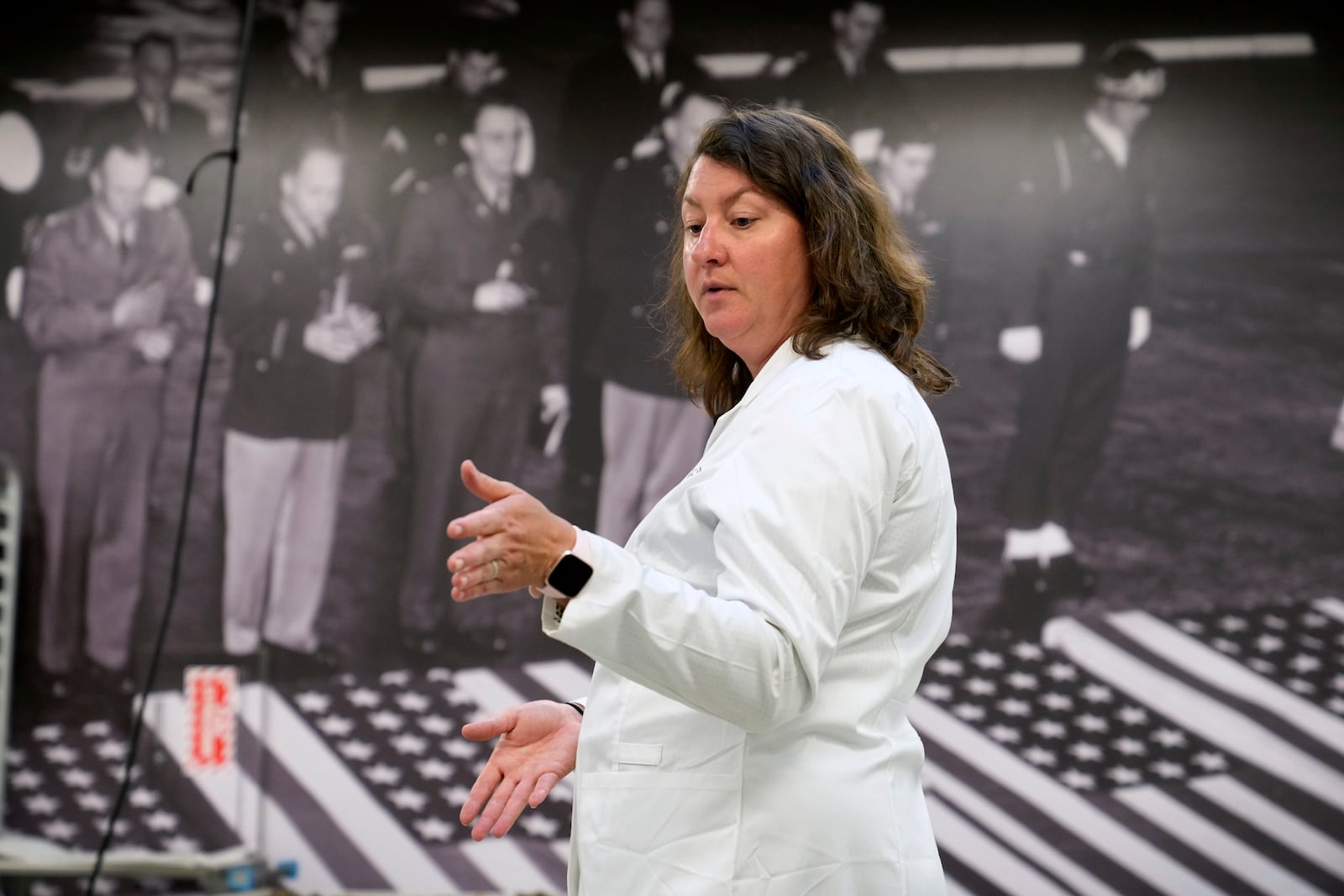 Defense POW/MIA Accounting Agency forensic anthropologist Carrie Brown speaks in a lab at Offutt Air Force Base, Monday, May 20, 2024, in Bellevue, Neb. Generations of American families have grown up without ever knowing exactly what happened to their loved ones who served in the military. But a lab tucked away above the bowling alley on Offutt Air Force Base in the Omaha suburbs and a sister lab in Hawaii that are part of the federal DPAA are steadily answering those lingering questions and offering about 200 families a year the chance to honor their relatives with a proper burial. (AP Photo/Charlie Neibergall)