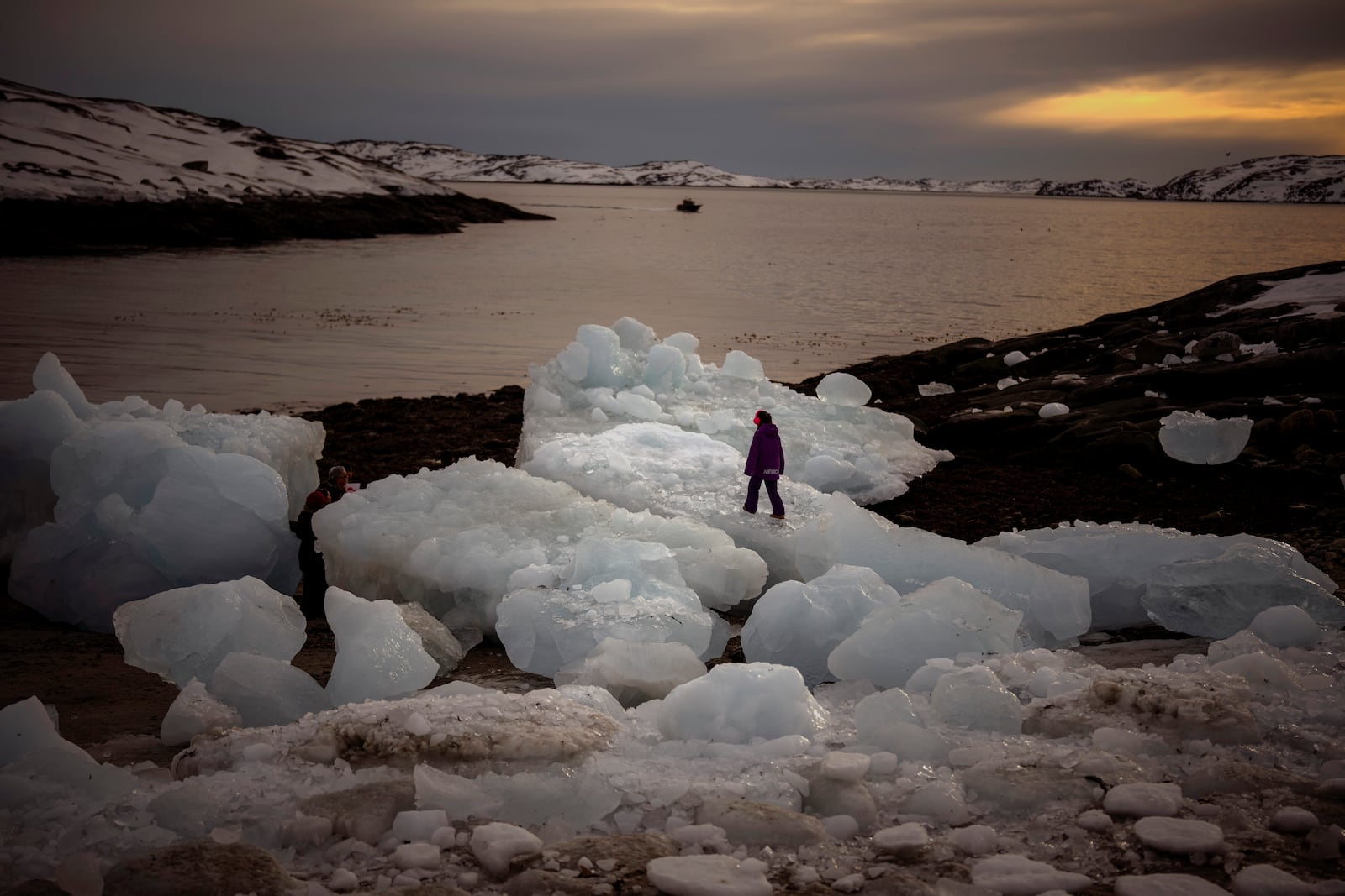 FILE - A kid walks on top of pieces of ice in Nuuk, Greenland, Feb. 16, 2025. (AP Photo/Emilio Morenatti, File)