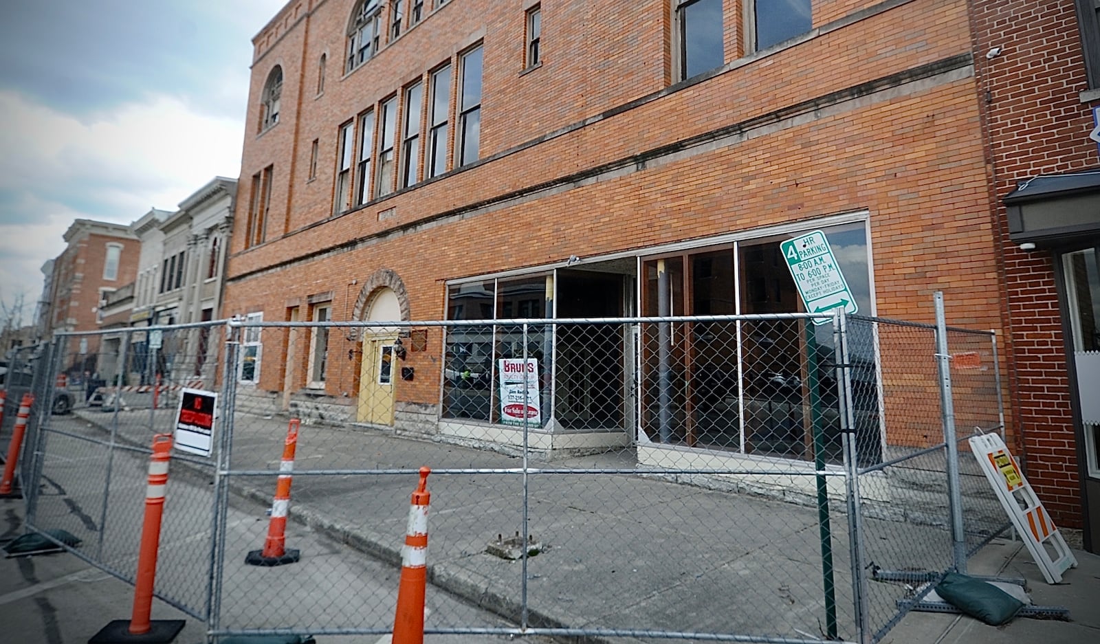 The sidewalk and street parking in front of the Tavern building on West Main Street in Troy have been closed for three years. MARSHALL GORBY / STAFF