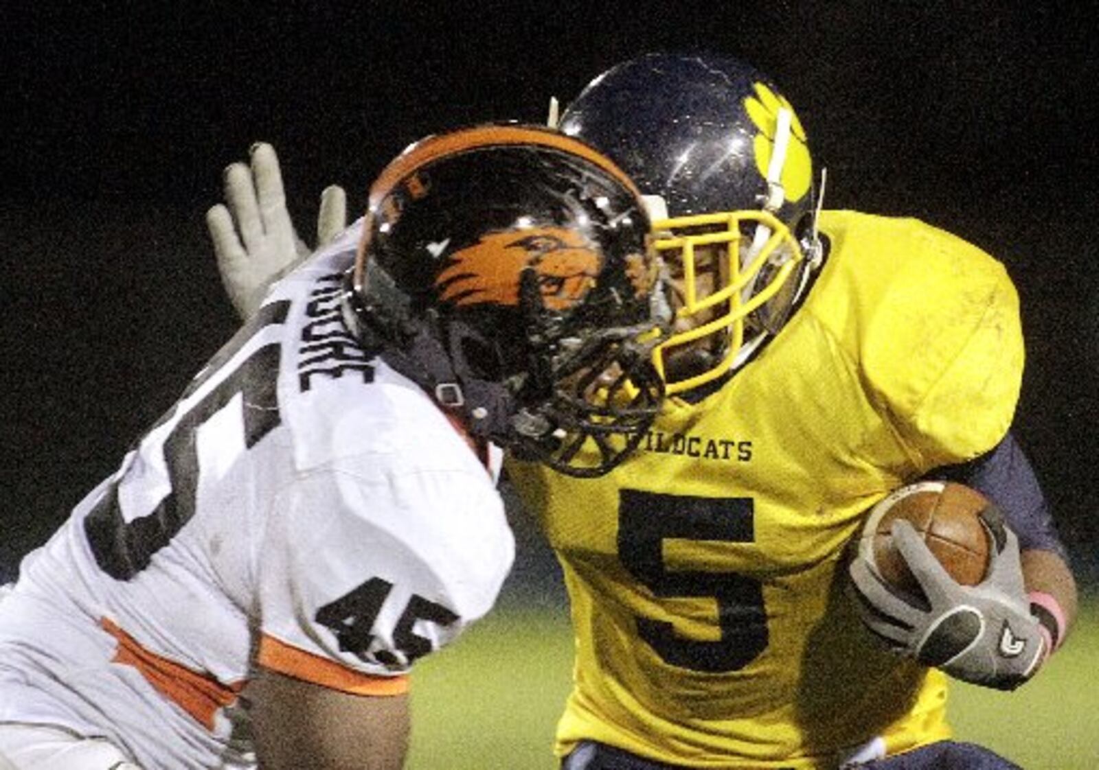 Corey Timmons (5) of Springfield is tackled by Airius Moore (45) of Beavercreek during Friday night's football game at Evans Stadium in Springfield on October 14, 2011. Staff Photo by Barbara J. Perenic