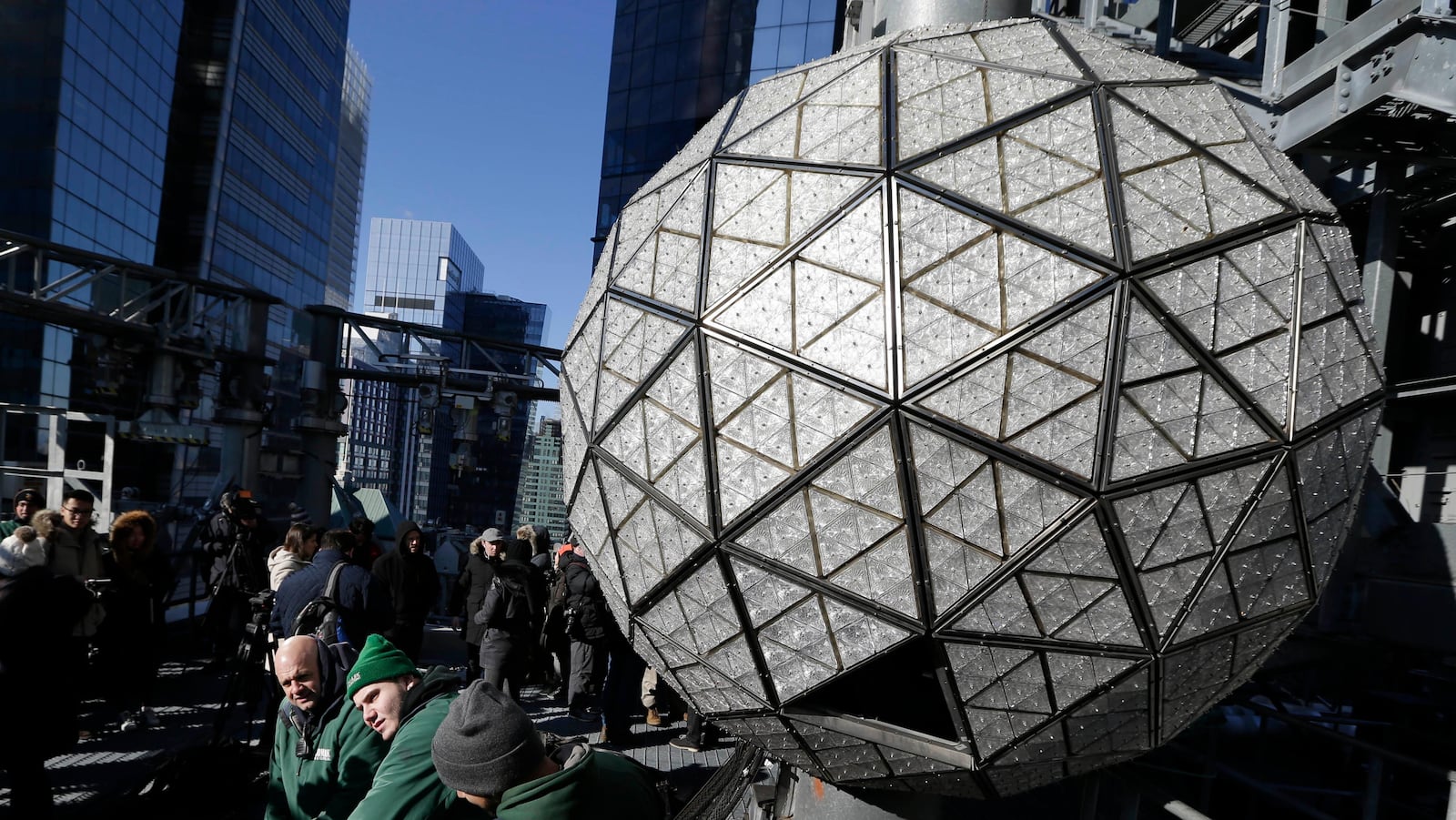 Workers prepare to install the last panels on the New Year's Eve ball above Times Square, New York, Wednesday, Dec. 27, 2017. The 12-foot diameter ball carries over 2600 Waterford crystals and is lit by more than 32,000 LEDs. (AP Photo/Seth Wenig)