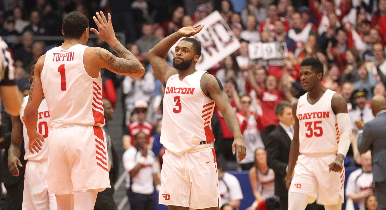 Dayton’s Trey Landers slaps hands with Obi Toppin after a dunk by Toppin against La Salle on Wednesday, March 6, 2019, at UD Arena. David Jablonski/Staff