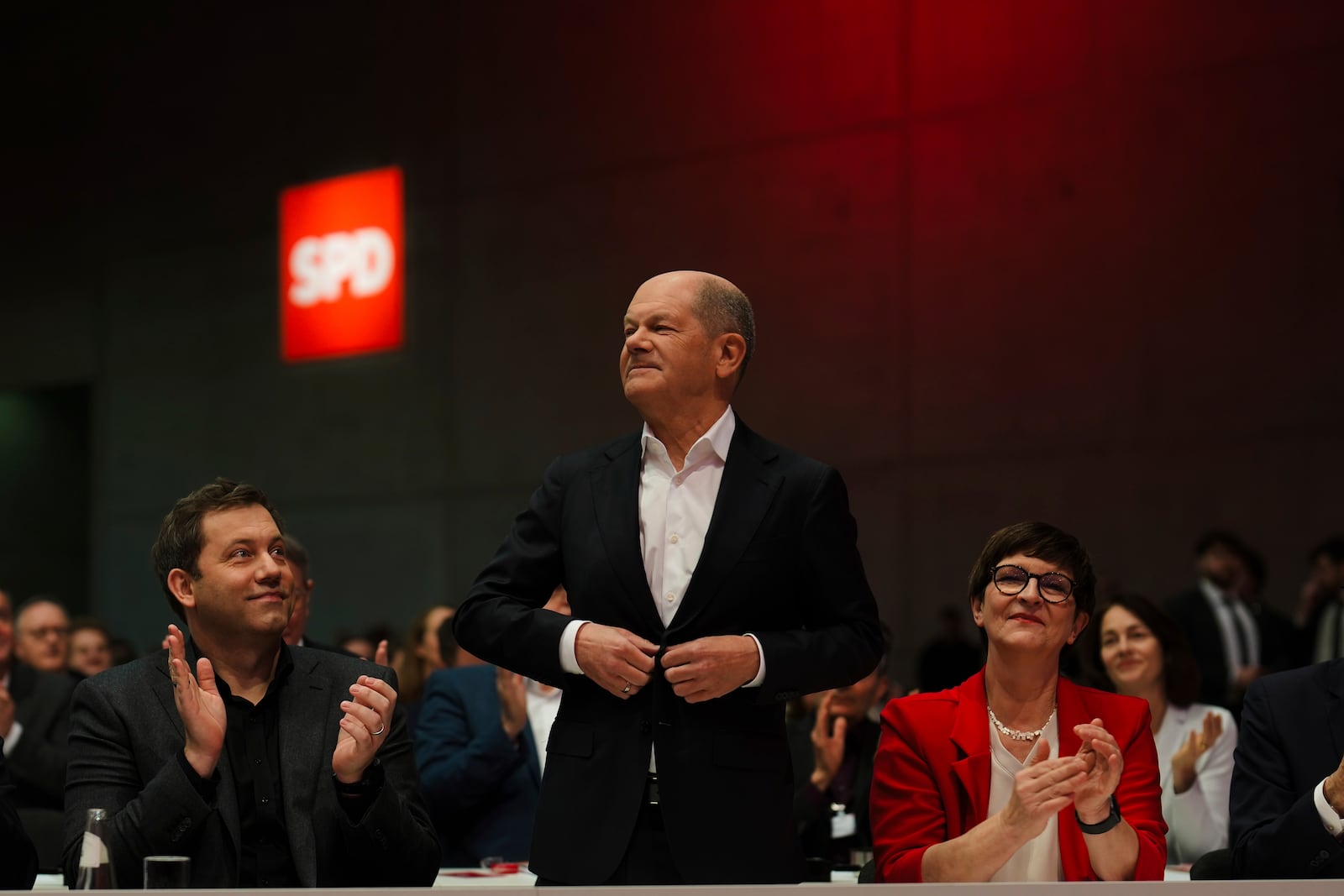 German Chancellor Olaf Scholz, center, stands between party leader Lars Klingbeil, left and Saskia Esken, right, as he arrives at a special party convention of the Social Democratic Party, SPD, in Berlin, Germany, Saturday, Jan. 11, 2025. (AP Photo/Markus Schreiber)