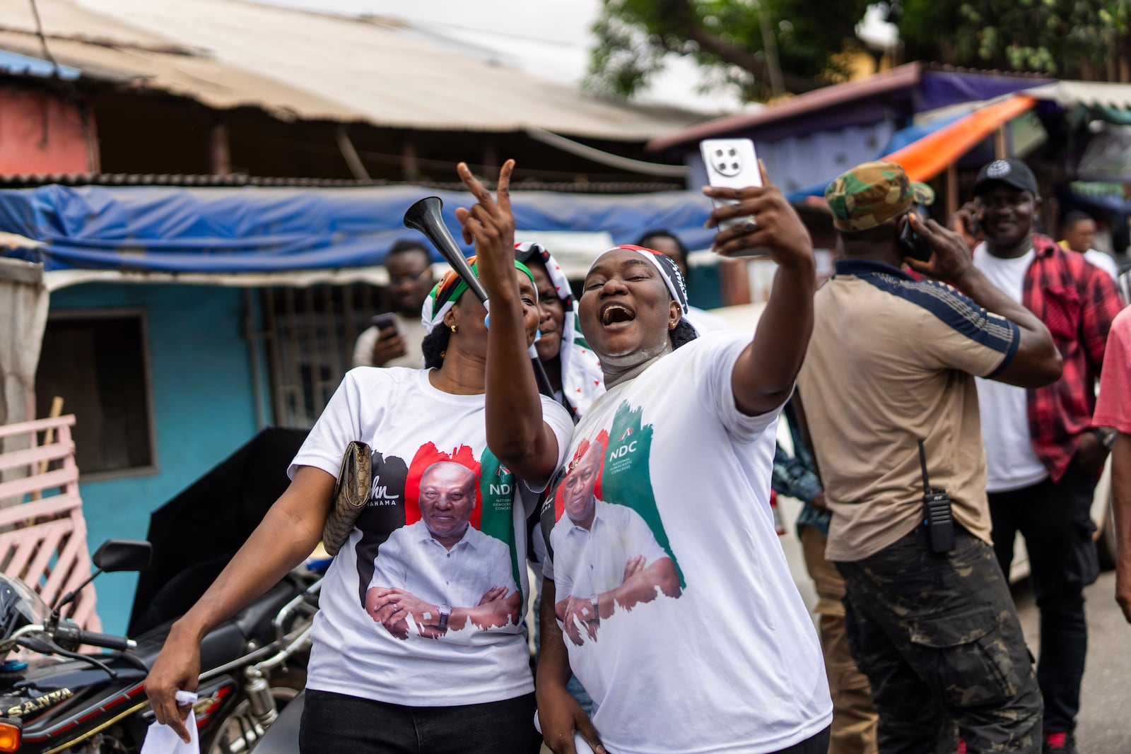 Supporters of opposition candidate and former President John Dramani Mahama celebrate his victory after his opponent Ghana’s vice president and ruling party candidate, Mahamudu Bawumia conceded in Accra, Ghana, Sunday, December 8, 2024. (AP Photo/Jerome Delay)