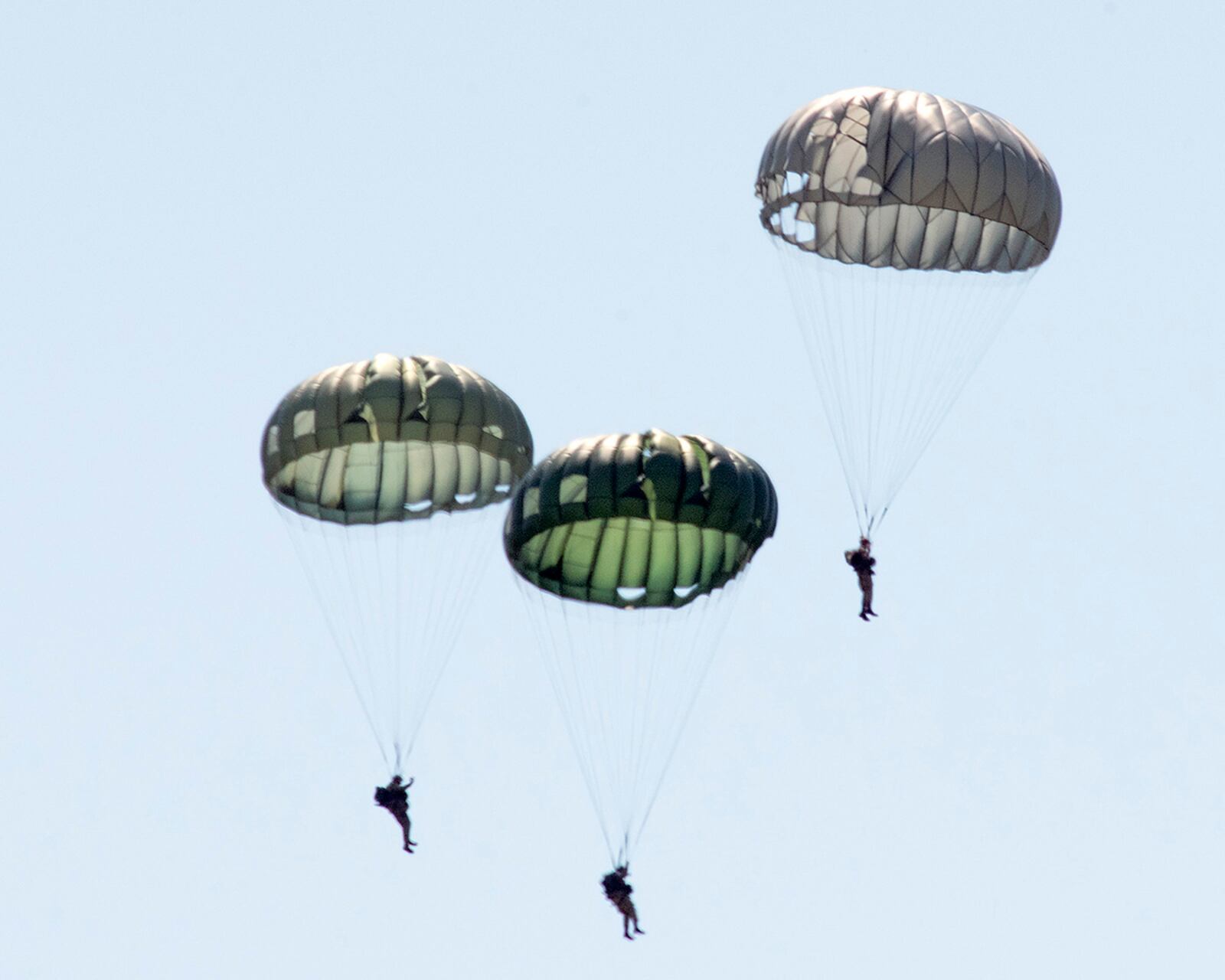 World War II paratroop reenactors float down toward their landing zone near the National Museum of the U.S. Air Force on April 27 at Wright-Patterson Air Force Base. A total of 17 reenactors jumped from two WWII-era C-47 Skytrains that had also dropped paratroopers over Normandy on D-Day. U.S. AIR FORCE PHOTO/R.J. ORIEZ