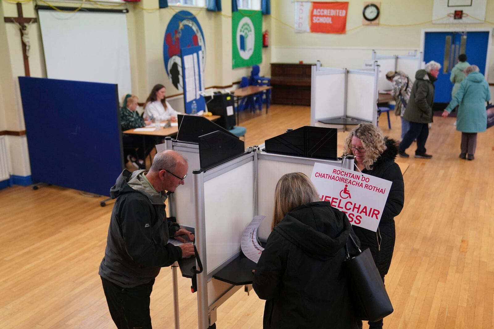 People cast their votes at Greenmount National School in Cork, as voters go to polls the for the 2024 General Election in Ireland, Friday, Nov. 29, 2024. (Jacob King/PA via AP)