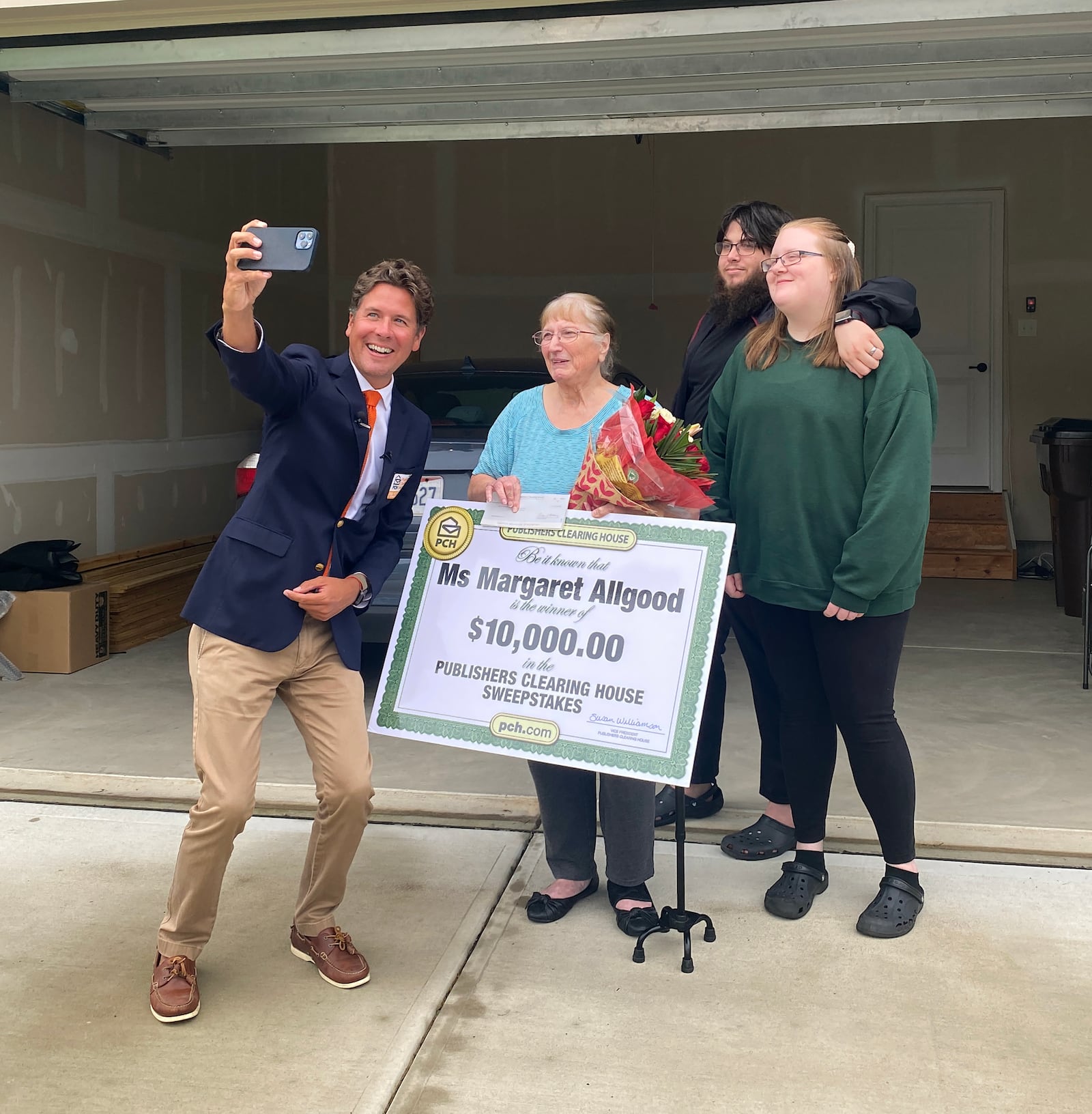 Howie Guja (L), a member of Publshers Clearning House, famous Prize Patrol snaps a "selfie" with $10,000 winner Margaret Allgood and her family, Jake Seaborn and his fiance Cozette Guillory. CONTRIBUTED