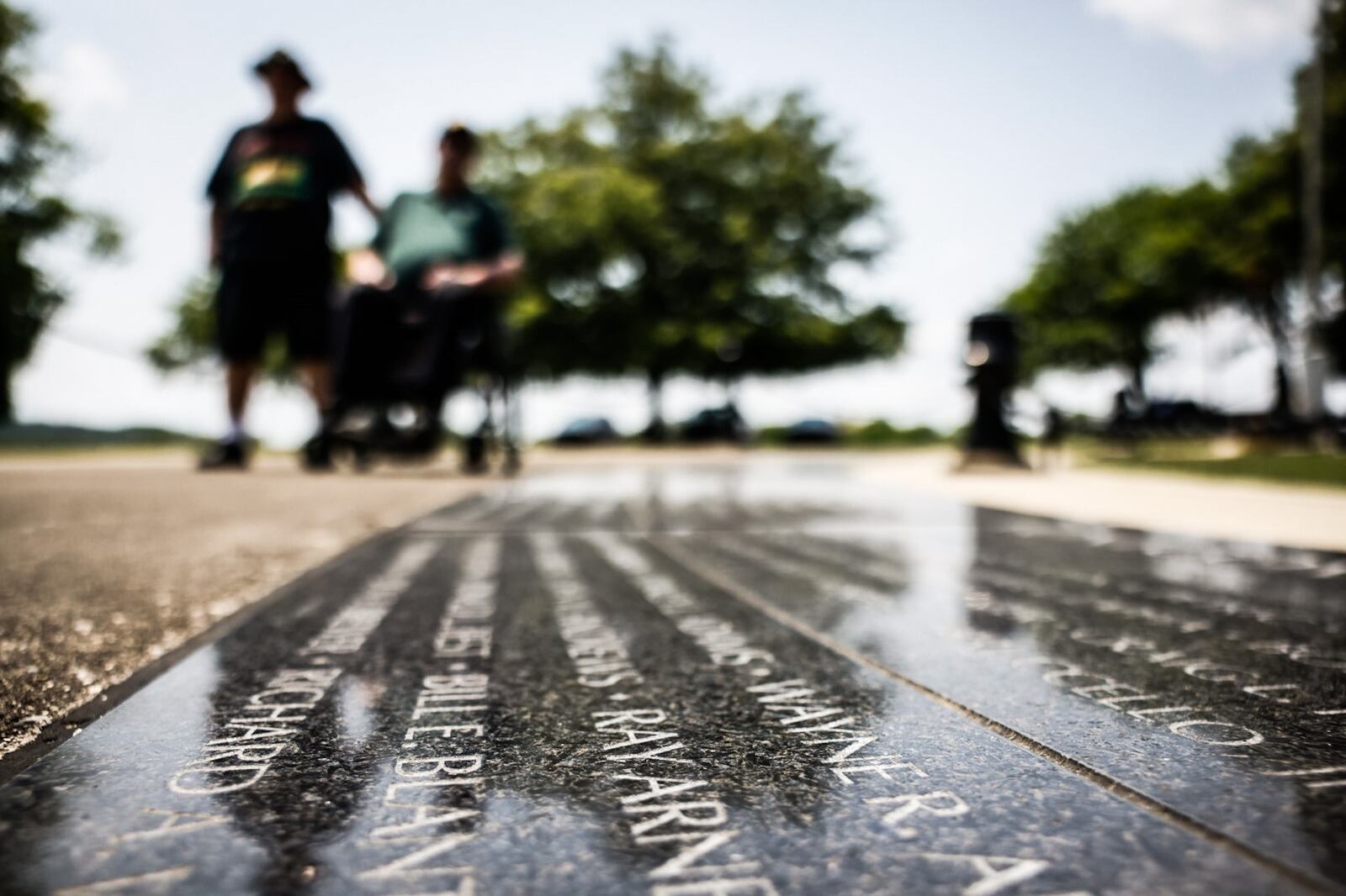 Vietnam veterans David Fuchs left, and Michael Vanderveen cleaned up the Vietnam Veterans Memorial Park in Dayton Friday May 19, 2023 in preparation of Memorial Day.  Vanderveen lost his legs in Vietnam War JIM NOELKER/STAFF