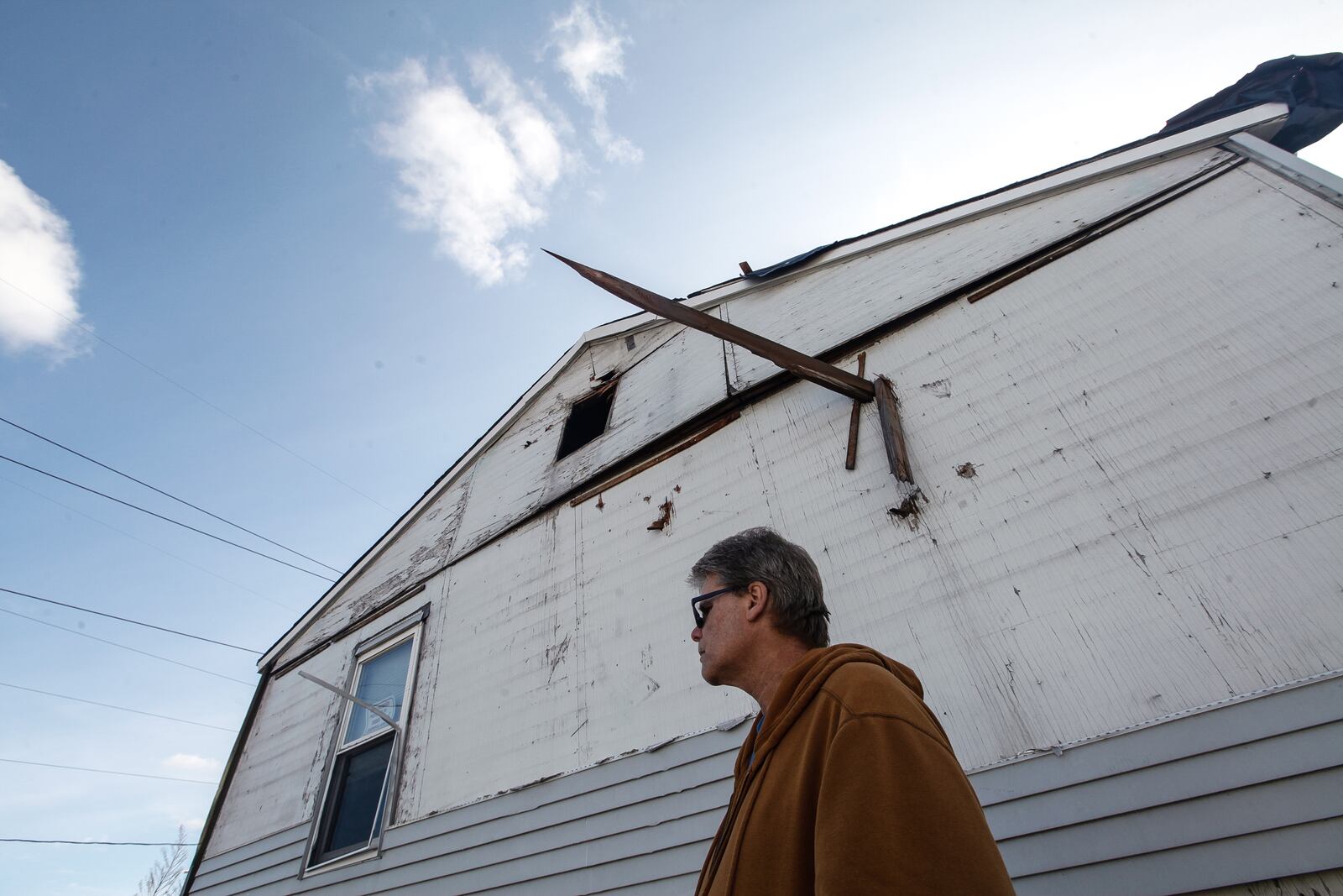 A board pierced the side of Steve Griffin's residence at Overlook Mutual Homes in Riverside. Right after the tornado, the house "looked like a snow globe," he said. "All the dirt and all the dried out insulation from the attic and little pieces of leaves from them trees over there were floating in the air.â CHRIS STEWART / STAFF