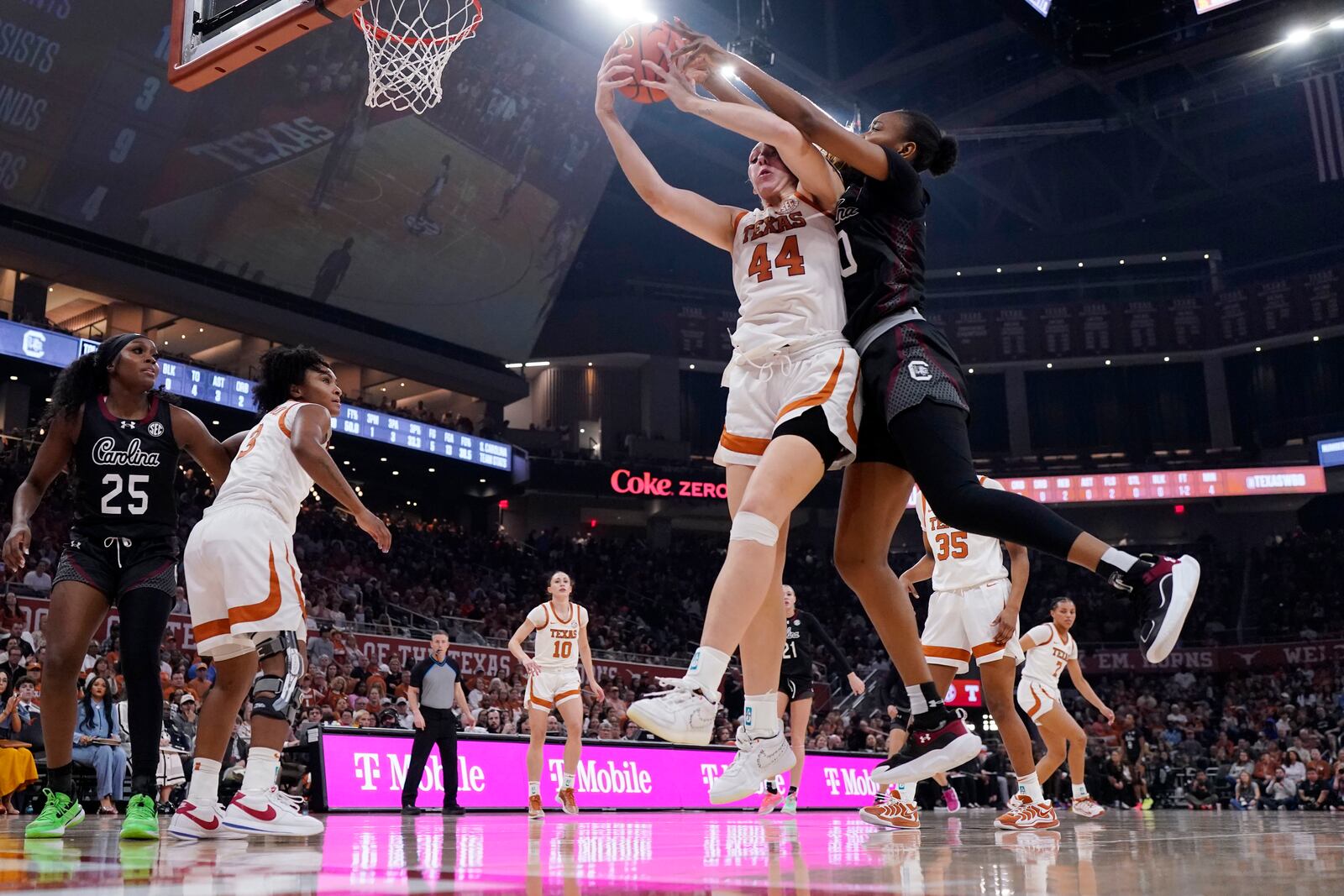 Texas forward Taylor Jones (44) and South Carolina forward Maryam Dauda, front right, reach for a rebound during the first half of an NCAA college basketball game in Austin, Texas, Sunday, Feb. 9, 2025. (AP Photo/Eric Gay)