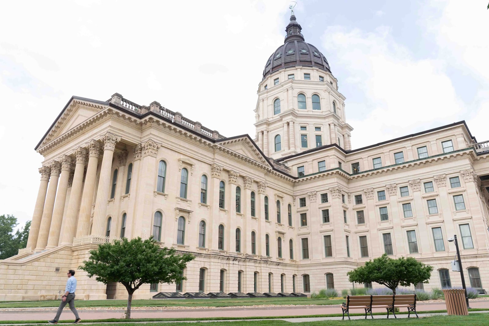 FILE - A man walks past the Kansas Statehouse in Topeka, Kan., June 17, 2024. (Evert Nelson/The Topeka Capital-Journal via AP File)