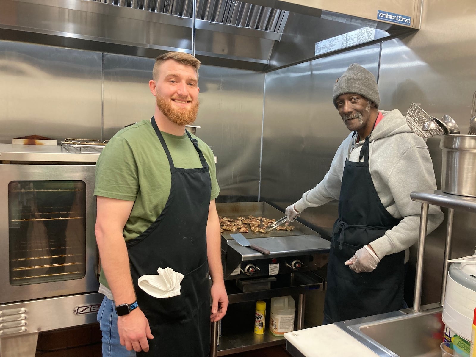 Staffer Derrick Ford and member Willard Hardy cook lunch. CONTRIBUTED