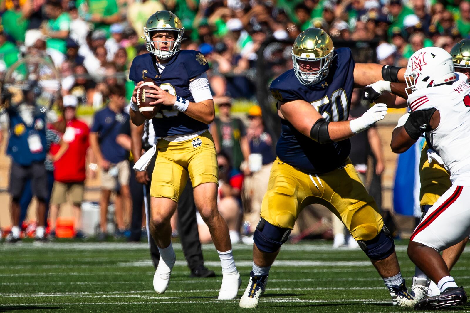 FILE - Notre Dame quarterback Riley Leonard (13) looks to pass as offensive lineman Rocco Spindler (50) blocks during the first half of an NCAA college football game against Miami (Ohio), Saturday, Sept. 21, 2024, in South Bend, Ind. (AP Photo/Michael Caterina, File)