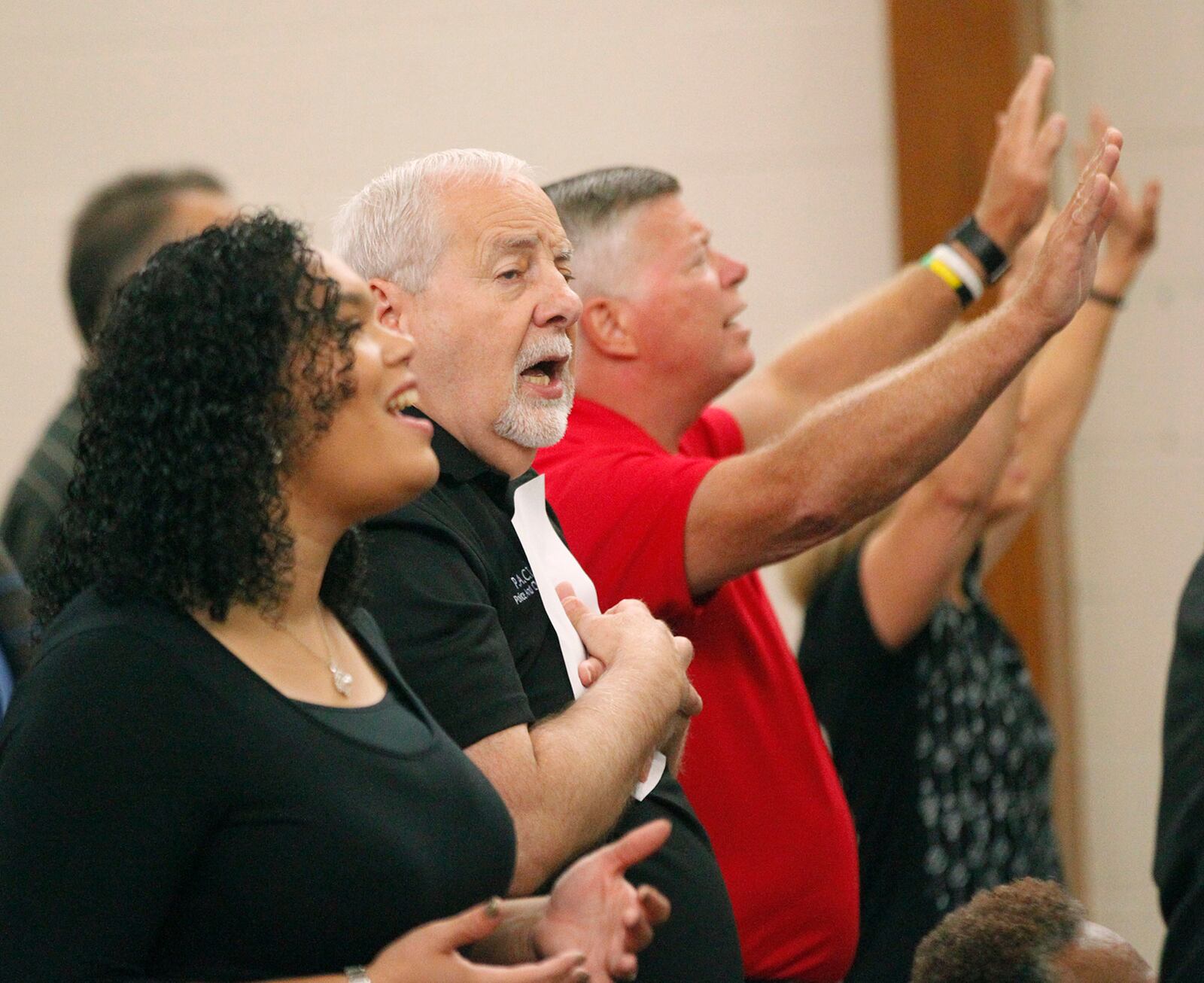 Participants sing during a prayer vigil hosted by The Tabernacle Baptist Church on Thursday in Dayton. Declare Dayton: A City-Wide Hour of Prayer featured local pastors who took turns praying and singing with participants for healing in the wake of the mass shooting and tornadoes.   TY GREENLEES / STAFF