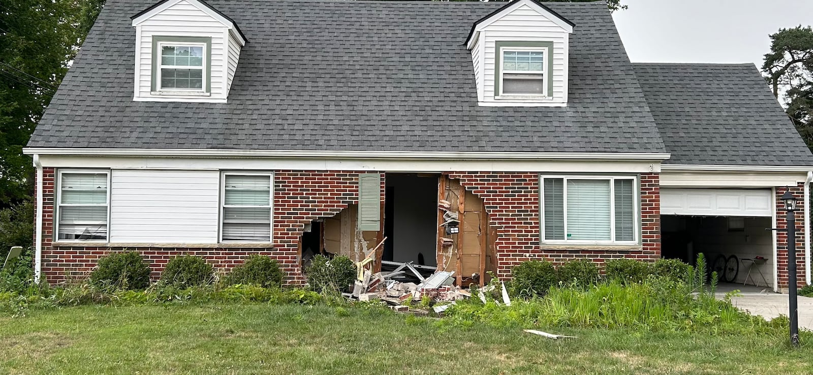 A car crashed into a house on Kenosha Road in Kettering on Monday, July 15, 2024. Police said no one was seriously injured. JEREMY P. KELLEY / STAFF