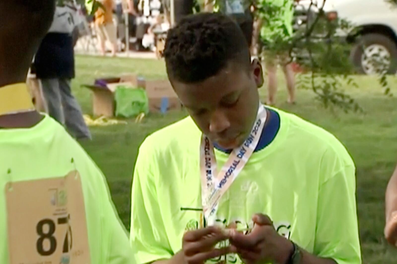 FILE - Ralph Yarl looks at a badge that he received after walking at a brain injury awareness event, May 29, 2023, in Kansas City, Mo. (KCTV via AP, File)