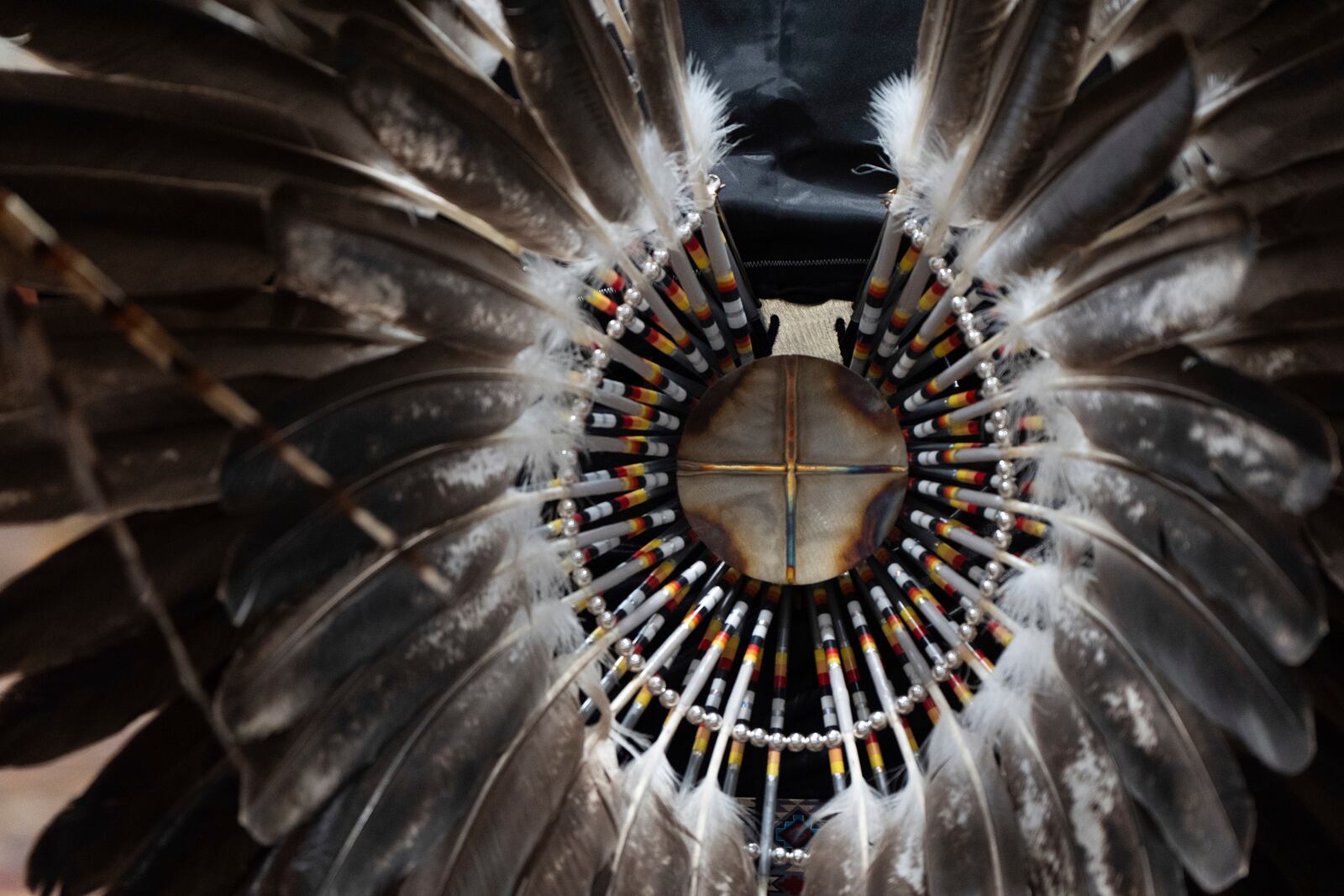 Feathers are displayed on regalia during a powwow at Chinook Winds Casino Resort, Saturday, Nov. 16, 2024, in Lincoln City, Ore. (AP Photo/Jenny Kane)