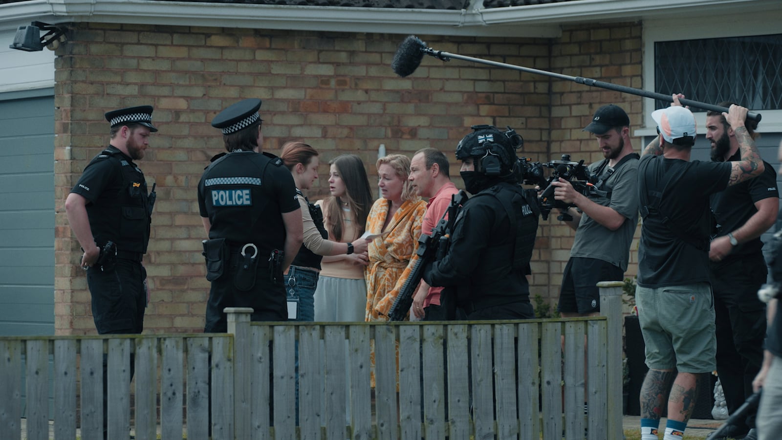 This image provided by Netflix shows Matthew Lewis, right, filming Faye Marsay, from left, Amelie Pease, Christine Tremarco, and Stephen Graham in a scene from "Adolescence." (Netflix via AP)