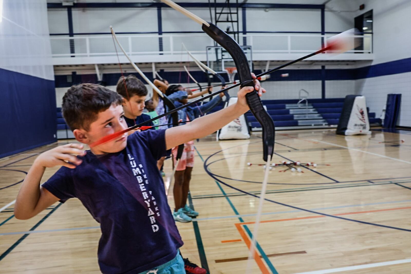 Washington Township summer camp member, Eli Szelestey learns to shoot a bow and arrow at the RecPlex Wednesday July 3, 2023. The RecPlex has lots of upgrades including 5,000 square feet of additional space. JIM NOELKER/STAFF