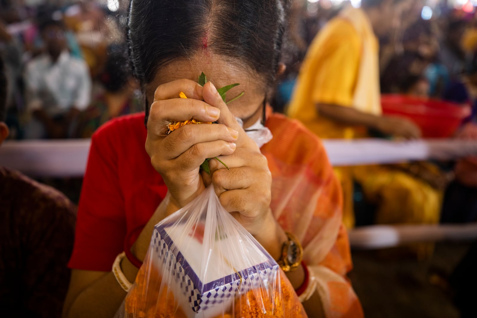 A woman offers prayer at the Dhakeshwari National Temple during the Durgapuja festival in Dhaka, Bangladesh, on Oct. 10, 2024. (AP Photo/Rajib Dhar)