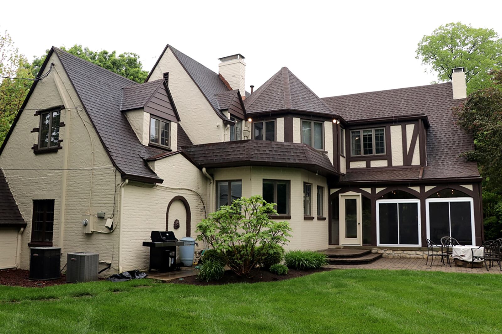 A door opens from the family room out to a 3-season, enclosed patio. The patio has terra-cotta tile flooring and sliding patio doors with arched windows above.  CONTRIBUTED PHOTO BY KATHY TYLER