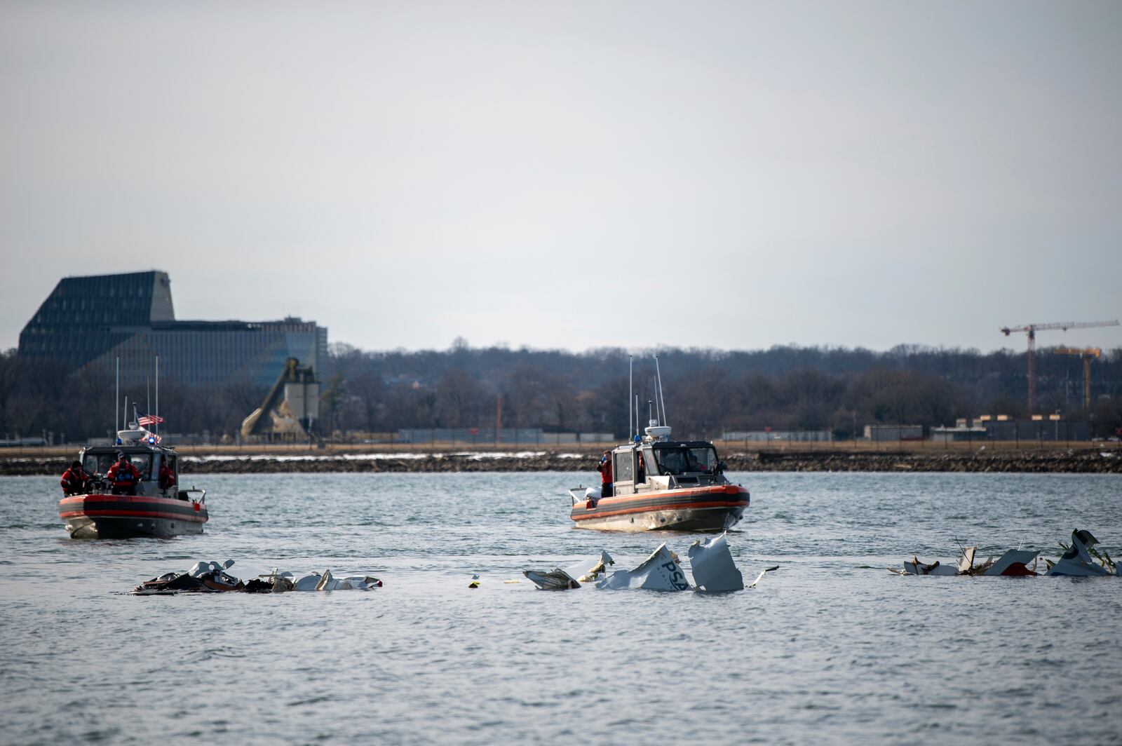 In this photo provided by the U.S. Coast Guard, response boat crews from Coast Guard stations Washington, Curtis Bay, Annapolis, Oxford and Crisfield enforce a safety zone around a wreckage site in the Potomac River from Ronald Reagan Washington National Airport, Thursday, Jan. 30, 2025, in Washington. (U.S. Coast Guard photo by Petty Officer 2nd Class Taylor Bacon)