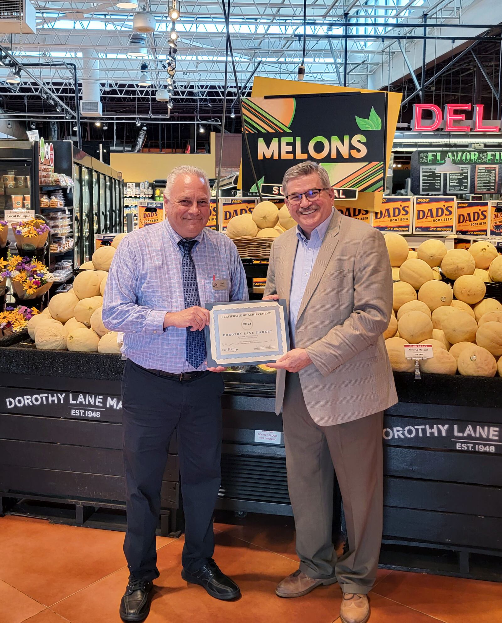 Montgomery County Auditor Karl Keith (right) presents store manager Fred Pfeiffer with a certificate at Dorothy Lane Market in Washington Twp. CONTRIBUTED