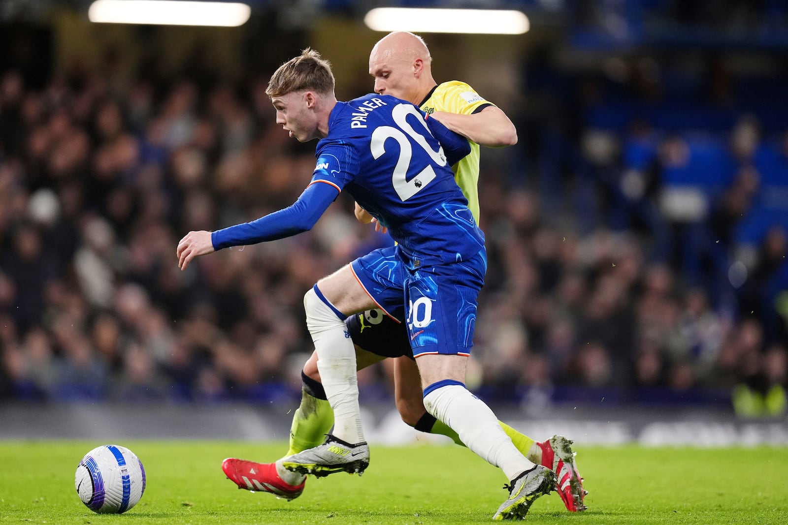 Chelsea's Cole Palmer, left, and Southampton's Will Smallbone battle for the ball during the English Premier League soccer match between Chelsea and Southampton at Stamford Bridge, London, Tuesday, Feb. 25, 2025. (John Walton/PA via AP)