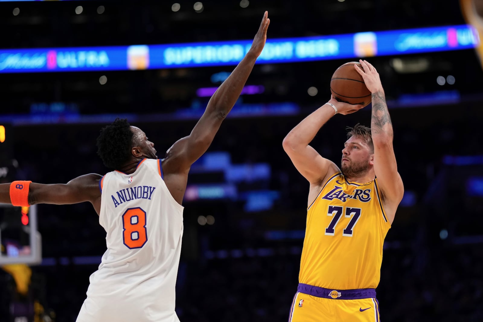 Los Angeles Lakers guard Luka Doncic, right, shoots as New York Knicks forward OG Anunoby defends during the first half of an NBA basketball game Thursday, March 6, 2025, in Los Angeles. (AP Photo/Mark J. Terrill)