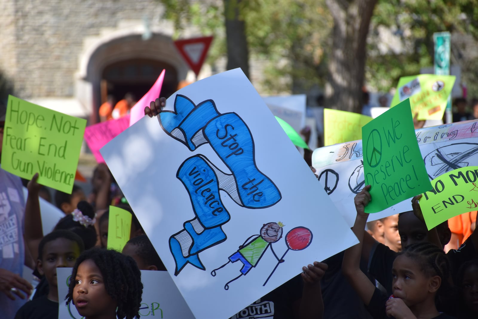 Kids, teens and adults marched down Broadway Street in northwest Dayton on Thursday as part of a peace march and rally in response to an increase in gun violence in the community. CORNELIUS FROLIK / STAFF