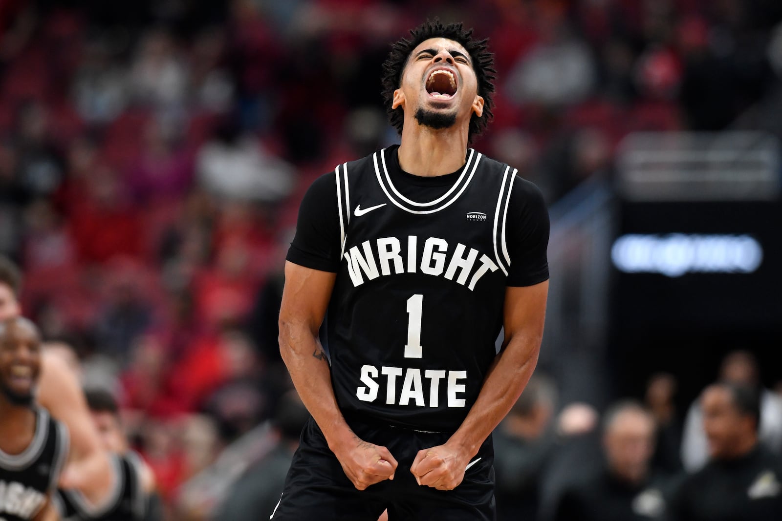 Wright State guard Trey Calvin (1) celebrates after hitting a last second shot to beat Louisville 73-72 in a NCAA college basketball game in Louisville, Ky., Saturday, Nov. 12, 2022. (AP Photo/Timothy D. Easley)