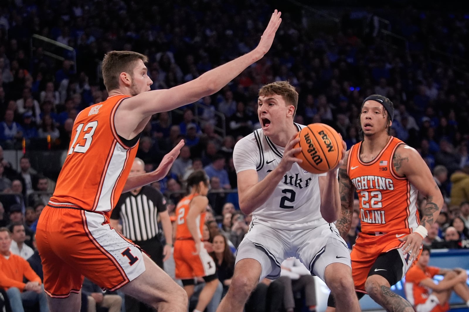 Illinois' Tomislav Ivisic (13) and Tre White (22) defend Duke's Cooper Flagg (2) during the first half of an NCAA college basketball game Saturday, Feb. 22, 2025, in New York. (AP Photo/Frank Franklin II)