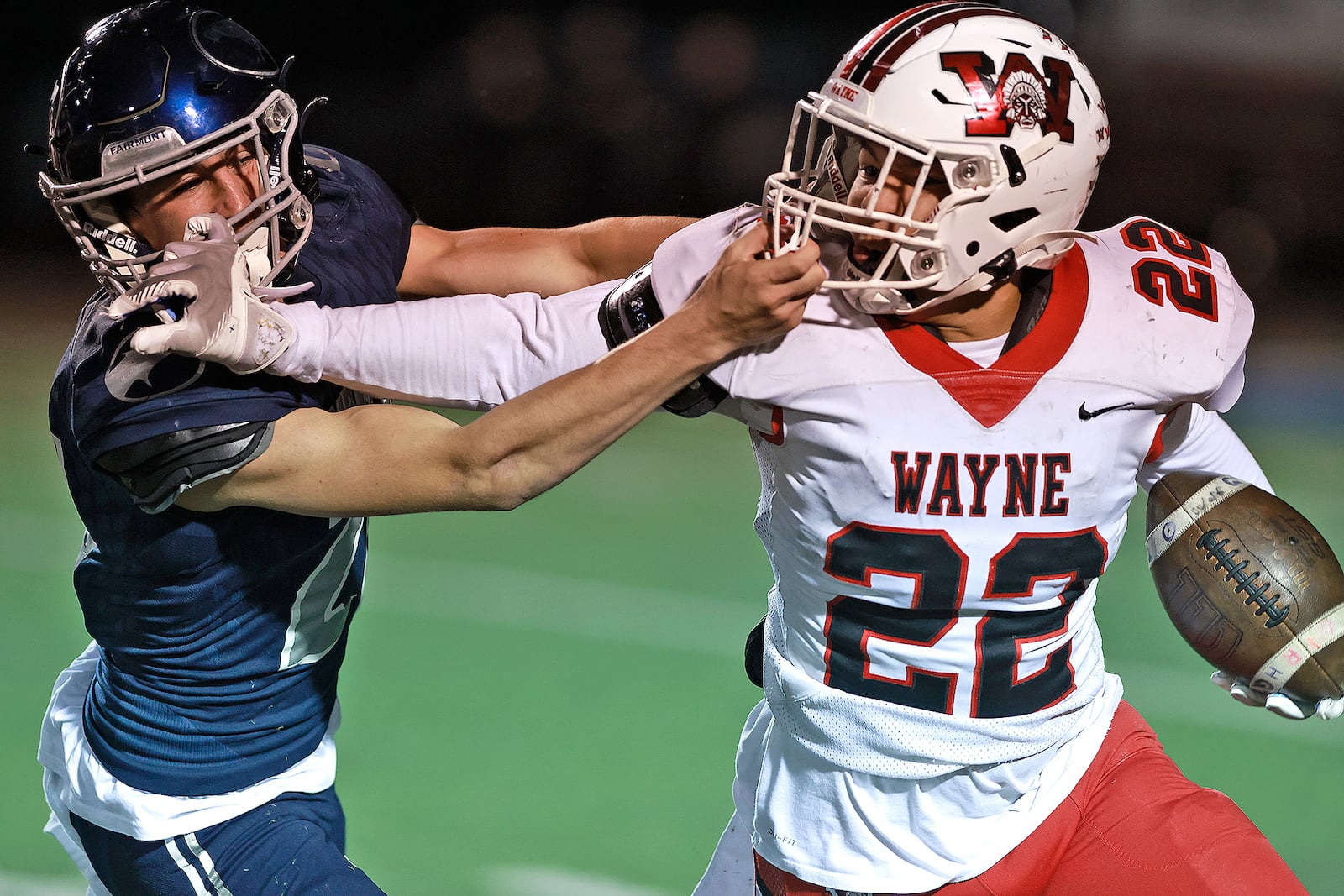 Wayne's Isaiah Thompson tries to avoid a tackle by Fairmont's Jack Probasco during round two of the playoffs Friday, Nov. 8, 2024. BILL LACKEY/STAFF