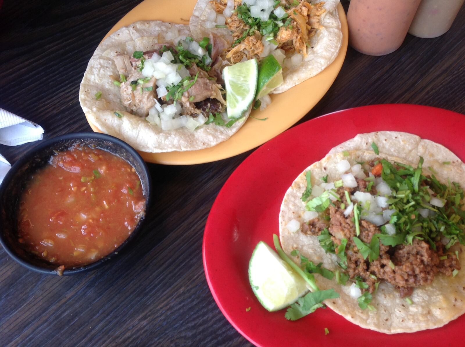 Taqueria Mixteca’s non-seafood tacos are $2.15 each. A corn (white or yellow), flour or crispy tortilla is served with choice of meat, cilantro, onions and a lime. Pictured are chicken, pork and chorizo tacos. (Photo by Amelia Robinson)