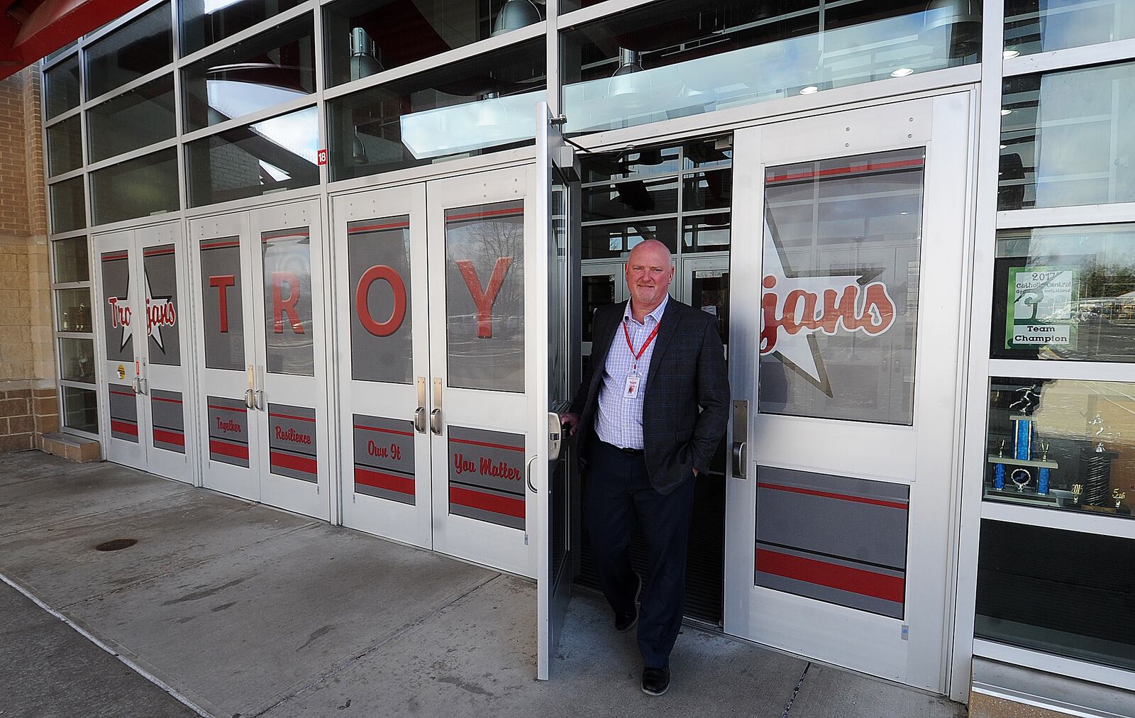 Troy schools Superintendent Chris Piper walks out the entrance of the high school Friday Feb. 3, 2023. Troy school officials listed several items they will buy with state funding including shatter-resistant security film for the glass on the entrances to its buildings. MARSHALL GORBY\STAFF