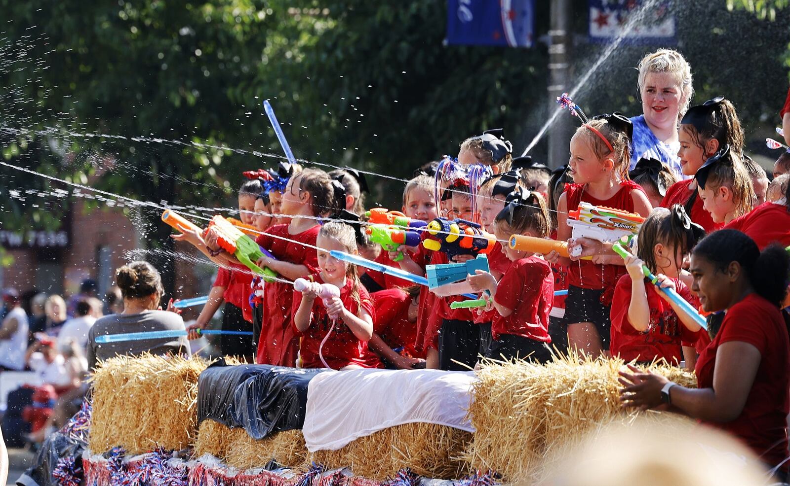 Parade attendees get drenched during Franklin's Independence Day Parade, known as "The Wettest Parade in Ohio", Tuesday, July 4, 2023 on Main Street in Franklin. Wet zones are set up at each intersection for a friendly water fight with many parade floats and fire trucks blasting water at bystanders. NICK GRAHAM/STAFF