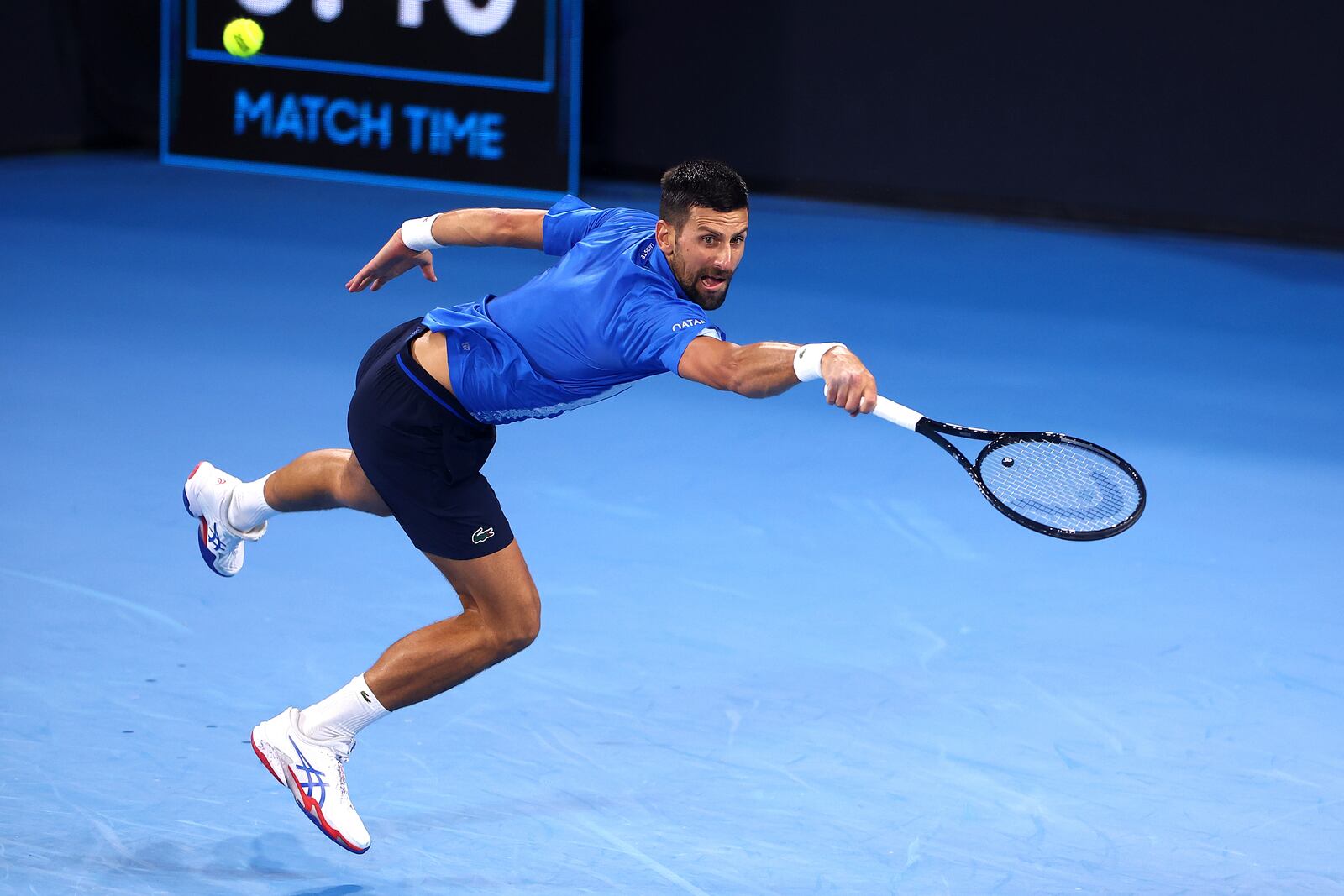 Serbia's Novak Djokovic returns a shot to USA's Reilly Opelka during their match at the Brisbane International, in Brisbane, Australia, Friday, Jan. 3, 2025. (AP Photo/Pat Hoelscher)