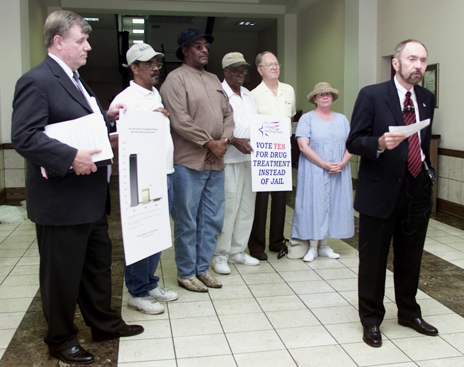 Archived photo: State Campaign Director Edward Orlett with supporters (LtoR) Brian Usher, Rev. Donald C. Smith-investigator from Dayton NAACP, Haskey Staley, investigator from Dayton NAACP, Jessie Gooding-president of Dayton NAACP, Don Tobias, Dawn Tobias giving press conference on new drug policy laws.