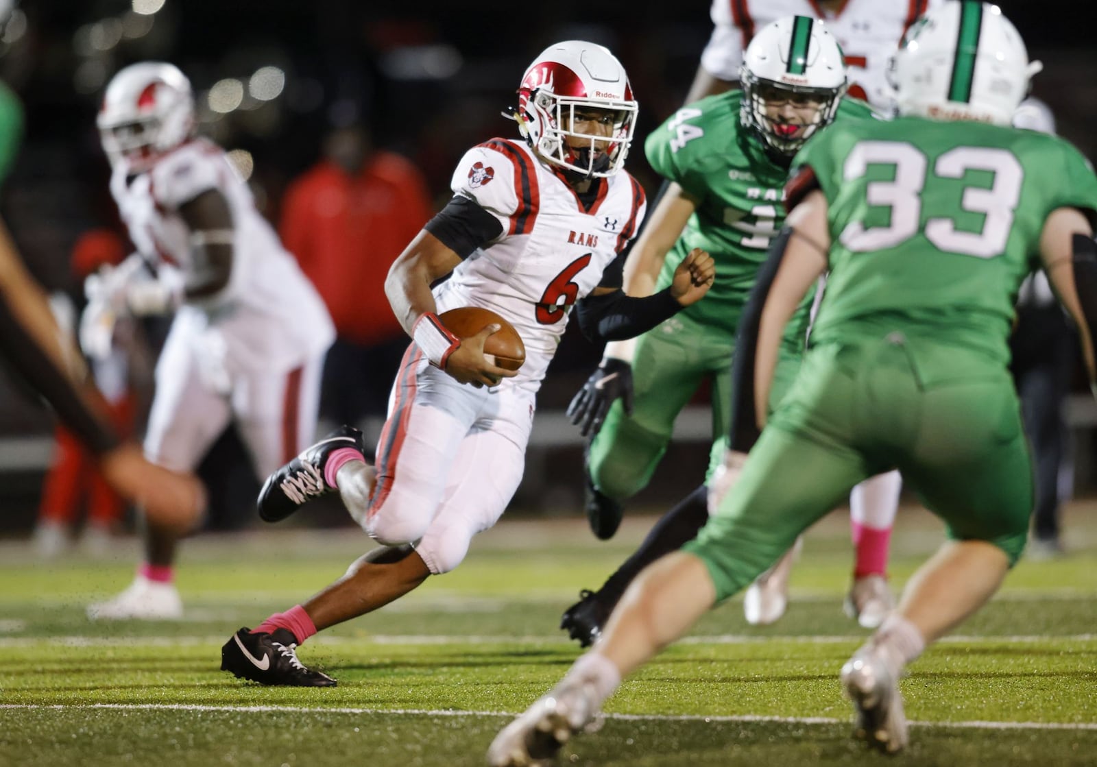 Trotwood-Madison quarterback Dallas Shehee looks to avoid Badin tacklers during Friday night's Division II, Region 8 playoff game at Fairfield. NIck Graham/STAFF